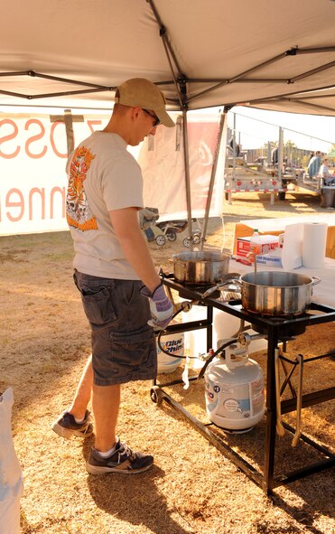 Airman 1st Class Guido Liverati, 7th Operations Support Squadron, prepares funnel cakes to sell to individuals attending Comedy Under the Stars, Sept. 23, 2011, at Dyess Air Force Base Texas. The 7th OSS sells food to raise money for unit activities. (U.S. Air Force photo by Airman 1st Class Cierra Bullock/Released)