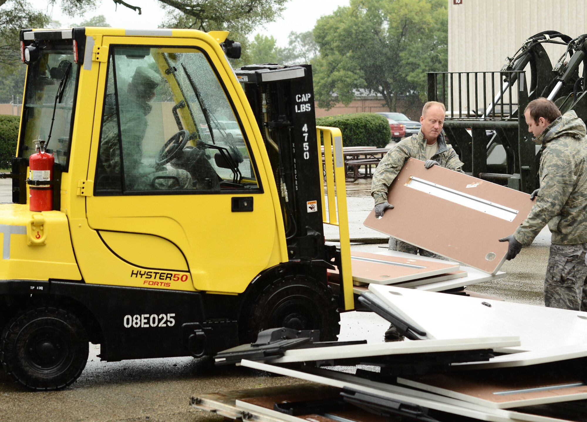 WRIGHT-PATTERSON AIR FORCE BASE, Ohio – From left to right, Tech. Sgt. Donald Griffen and Senior Airman Daniel Burden, both from the 87th Aerial Port Squadron, load unassembled workstation onto a forklift Sept 7 that is being put into storage for the wing until upcoming renovations to wing facilities are complete. (U.S. Air Force photo/Senior Airman Mikhail Berlin)