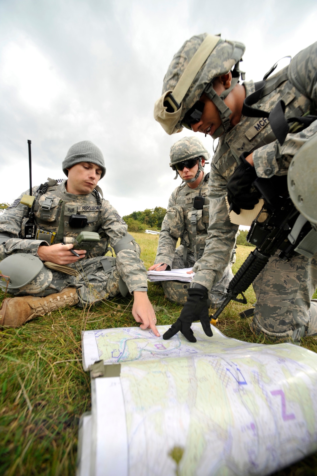 U.S. Air Force Staff Sgt. Caleb Ferguson, Airman 1st Class Anthony McFarlin and Senior Airman Terry Burk, 48 th Security Forces Squadron, plan their team’s mission during Creek Defender training course Sept. 22 in Baumholder, Germany. Security Forces members from throughout U.S. Air Forces Europe attended the training course in preparation for deployment. (Photo by Staff Sgt. Tyrona Lawson)

 


