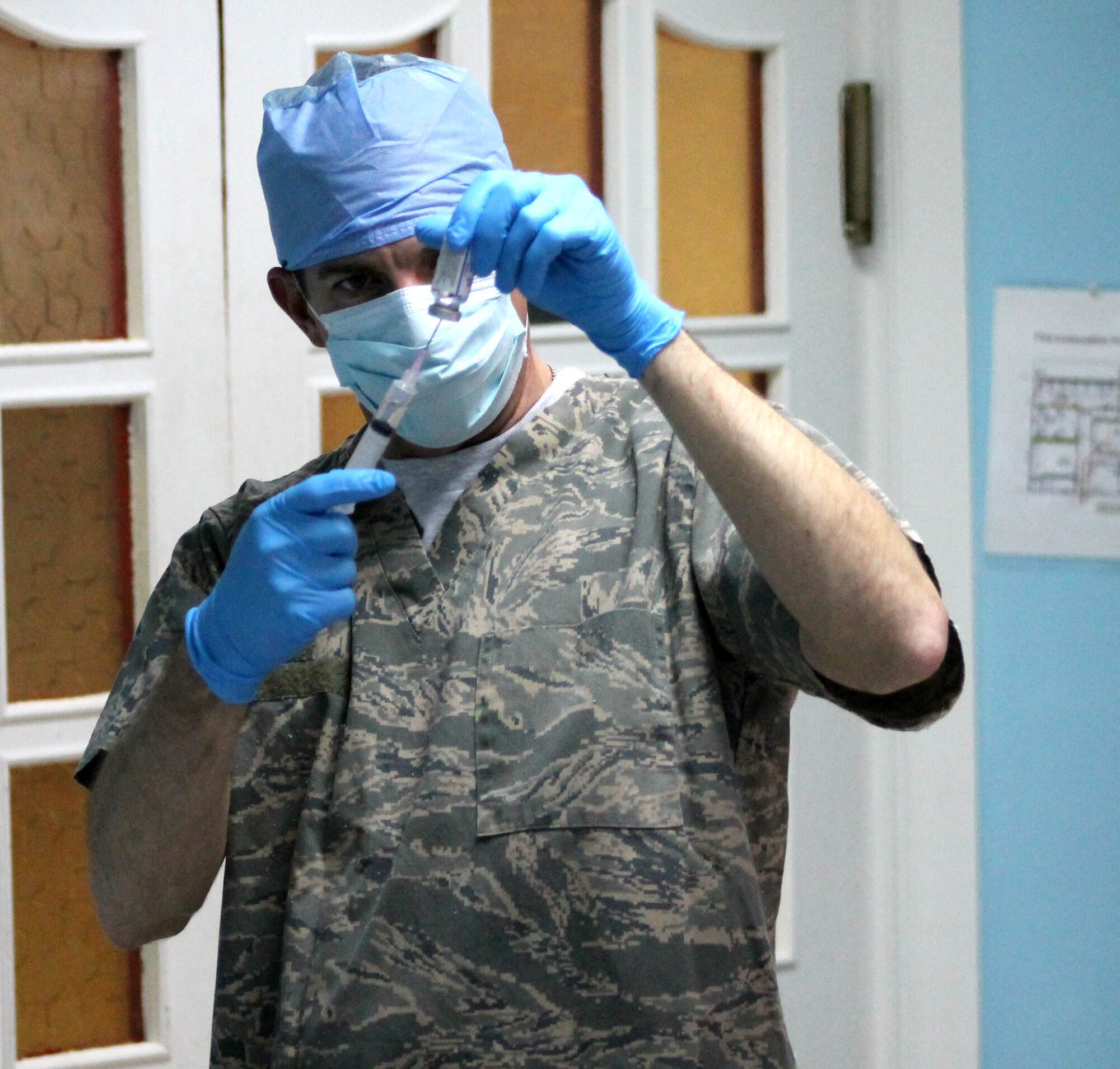 Capt. David Welch, 321st Expeditionary Medical Squadron pharmacist, fills a syringe with Thrombin Sept. 9, 2011, at Kirkuk Regional Air Base, Iraq. Welch left his job as a retail pharmacist at Revco to serve in the Air Force. (Courtesy Photo)