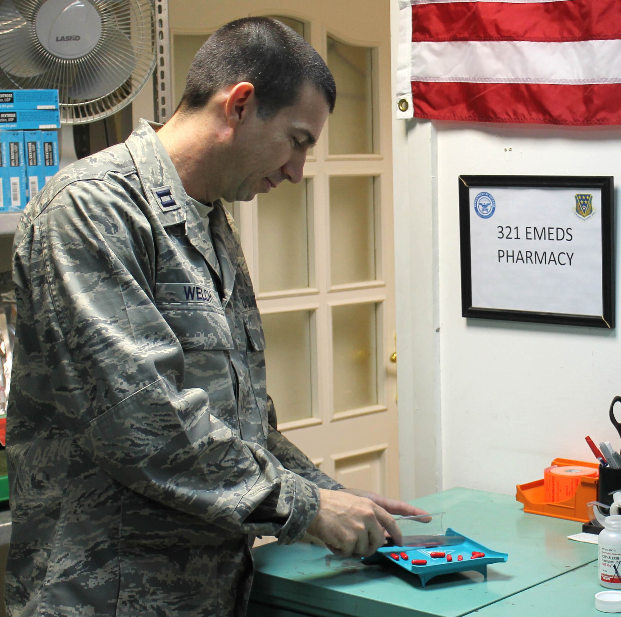 Capt. David Welch, 321st Expeditionary Medical Squadron pharmacist, fills a prescription Sept. 9, 2011, at Kirkuk Regional Air Base, Iraq. Welch left his job as a retail pharmacist at Revco to serve in the Air Force. (Courtesy Photo)