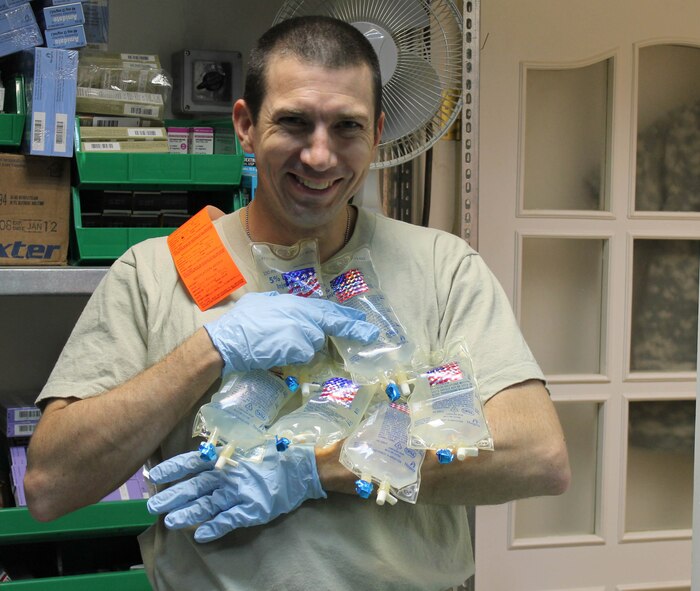 Capt. David Welch, 321st Expeditionary Medical Squadron pharmacist, carries IV bags Sept. 9, 2011, at Kirkuk Regional Air Base, Iraq. Welch left his job as a retail pharmacist at Revco to serve in the Air Force. (Courtesy Photo)