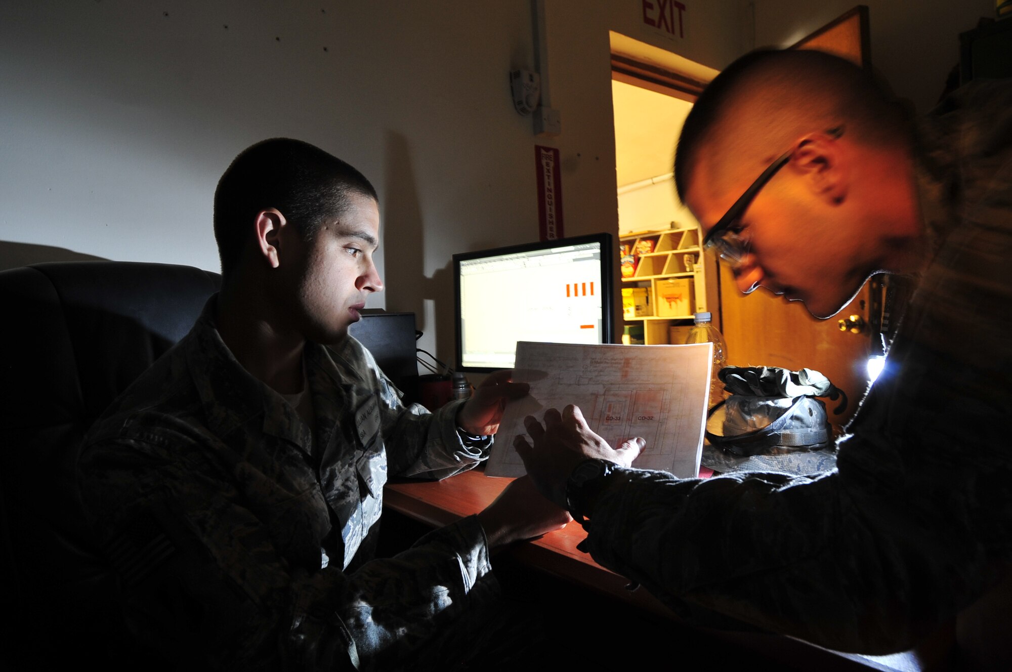 Senior Airman Julian Alberni, 467th Expeditionary Prime BEEF Squadron engineering journeyman, discusses building designs with 1st Lt. Nicholas Lopez, 467th EPBS project manager, at Ali Base, Iraq, on Aug. 31, 2011. Prime BEEF Airmen on Ali Base primarily create surveys and design work while the 389th Engineer Company soldiers implement the designs.  Alberni is deployed from Dyess Air Force Base, Texas, and is from Lake Tahoe, Calif.  Lopez is deployed from Joint Base Langley-Eustis, Va., and is from Palmdale, Calif. (U. S. Air Force photo/Master Sgt. Cecilio Ricardo)