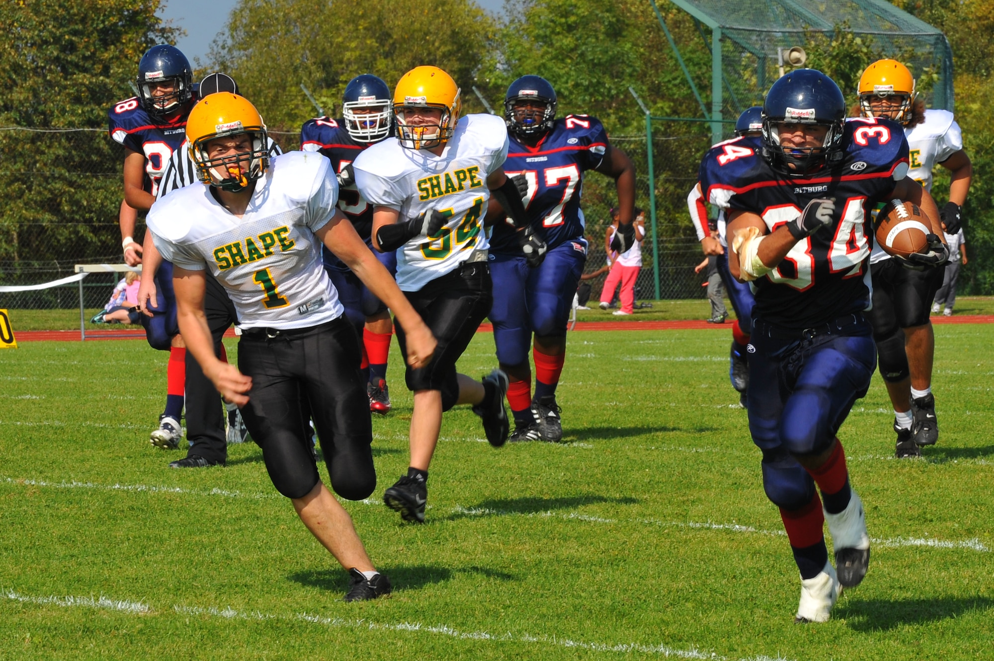 BITBURG ANNEX, Germany – Austin Schmidt, number 34, Bitburg High School Barons running back, carries the ball to the end zone for a touchdown during the Bitburg High School homecoming football game here Sept. 24. The Bitburg Barons defeated the S.H.A.P.E. Sultans 56-20. (U.S. Air Force photo/Airman 1st Class Dillon Davis)
