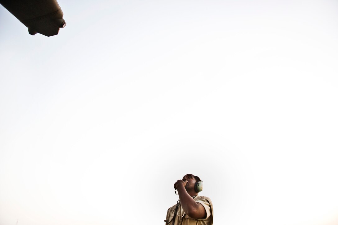 Staff Sgt Shaun Stallworth, 386th Expeditionary Aircraft  Maintenance Squadron, watches for movement on a the tail section flight control surfaces of a C-130 Hercules during a preflight inspection on September 7, 2011. As pilots make flight control inputs inside the plane, Staff Sgt Stallworth observes from outside to ensure the plane’s controls are functioning properly. (U.S. Air Force Photo by Master Sgt Jeffrey Allen)   