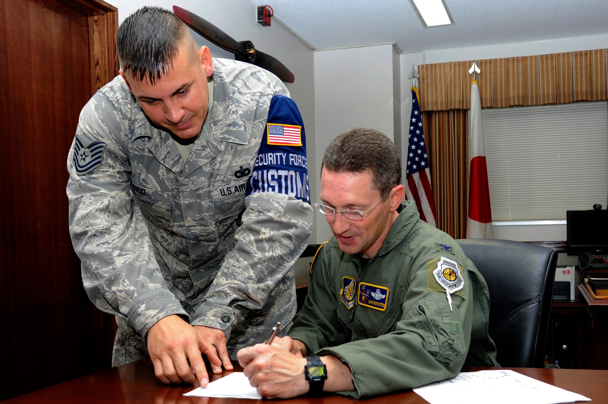 MISAWA AIR BASE, Japan - Tech. Sgt. Jason Kidd, left, 35th Security Forces Squadron, assists Col. Michael D. Rothstein, 35th Fighter Wing commander, with filling out his Air Force Sergeants Association membership form here 27 Sept. AFSA is a leading force on Capitol Hill and works closely with elected representatives and their staff members to assist in drafting proposals for legislation on issues related to military members and their families. AFSA also works closely with White House staff personnel and Pentagon officials to ensure that enlisted members' concerns are heard and acted upon. The mission of AFSA is to support and improve the quality of life, economic situation and well-being of Air Force enlisted personnel and their families. Rothstein is the first 35th Fighter Wing commander to join AFSA. (U.S. Air Force photo/Tech. Sgt. Marie Brown)