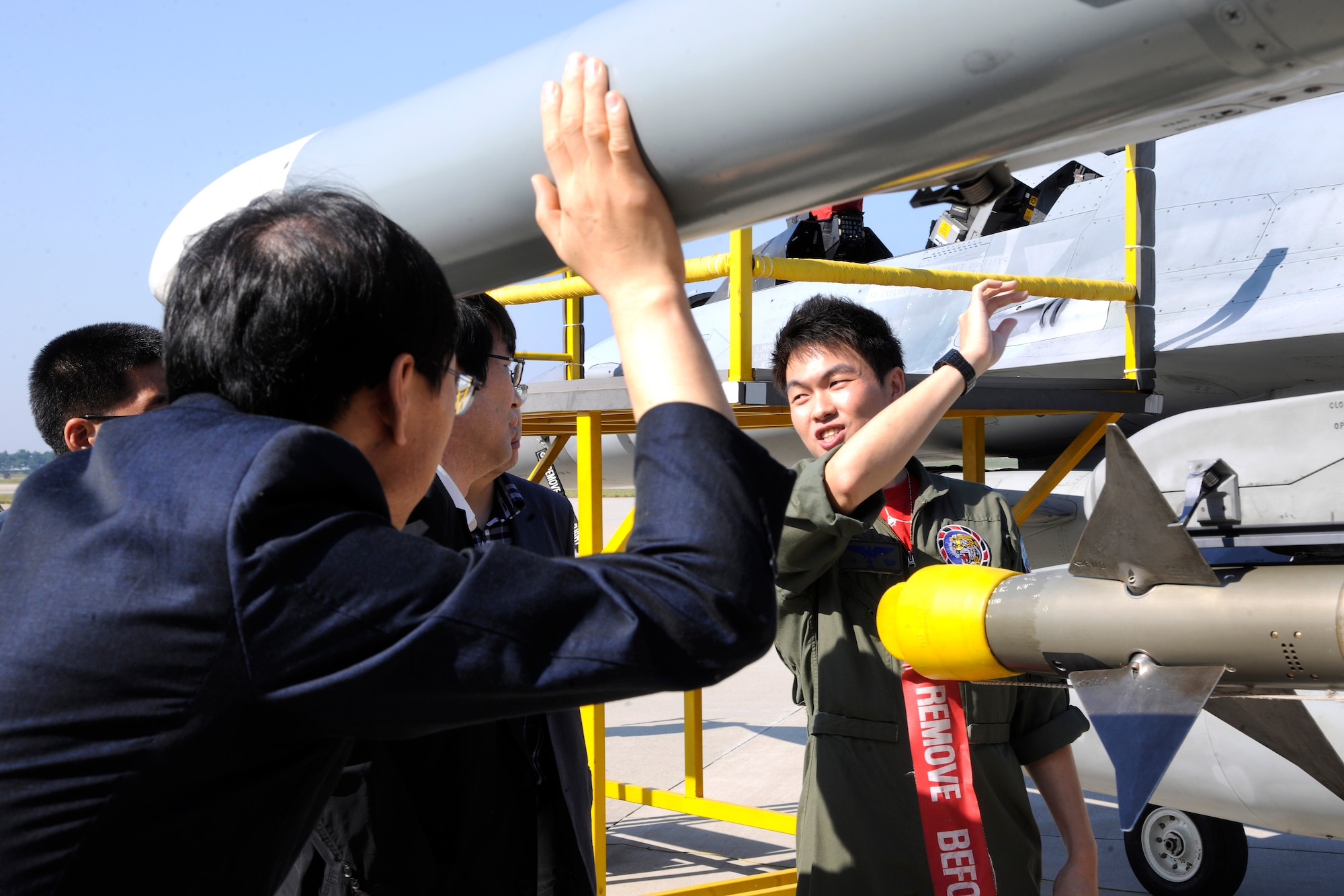 KUNSAN AIR BASE, Republic of Korea -- A member of the Republic of Korea Air Force briefs Wonkwang University Medical Center and Gunsan Medical Center executive leadership teams about their KF-16 Fighting Falcons here Sept 24. Wonkwang University and Gunsan Medical Centers leadership teams were invited by the 8th Medical Group commander and leadership to tour the base. The Wonkwang University and Gunsan Medical Centers are Kunsan AB’s referral hospitals of choice nearby who provide specialty care to Wolf Pack members when it is not available at the 8th MDG clinic. (U.S. Air Force photo/Staff Sgt. Rasheen A. Douglas)