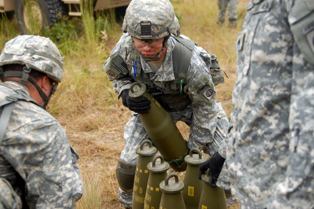 Army Spc. Jared D. Elzea moves a 155mm high-explosive round to a M777 ...