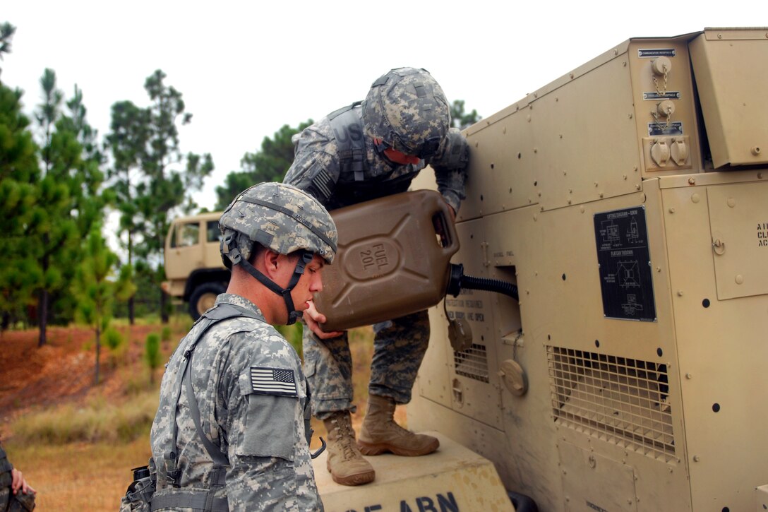 Army Pfc. Jeremy Pennington and Spc. Zachary Moore refuel a generator that provides power to a radar during a live-fire exercise on Fort Bragg, N.C., Sept. 21, 2011. Pennington and More are assigned to the 82nd Airborne Division's 26th Target Acquisition Battery, 18th Fires Brigade.
