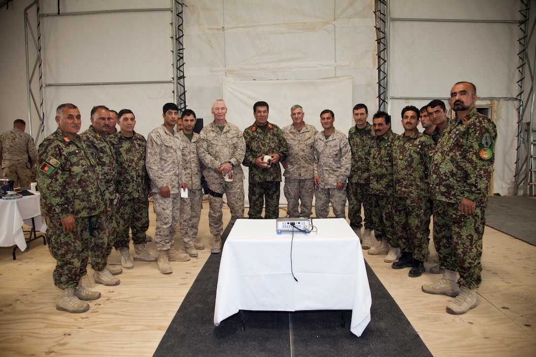 Maj. Gen. John Toolan, the commanding general of Regional Command Southwest and Maj. Gen. Glenn Walters, 2nd Marine Aircraft Wing (Forward) commanding general, stand among the leadership of the Afghan Army at a dinner for coalition leaders at Camp Leatherneck, Afghanistan, Sept. 28. U.S. Marines, British forces and Afghan soldiers have fought and worked together to quell the insurgency.