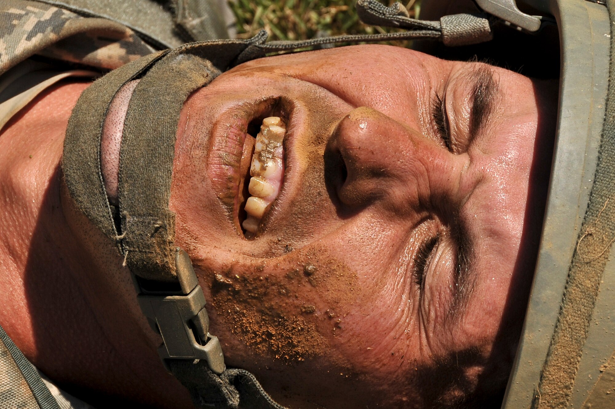 Master Sgt. Christopher Greek, 51st Security Forces Squadron flight chief, closes his eyes when he is chosen to be a simulated casualty during the confidence course portion of the Combat Readiness Course Sept. 27, 2011. The confidence course is an obstacle course that tests the participant’s abilities to survive as a team while communicating when placed in stressful situations. (U.S. Air Force photo/Senior Airman Adam Grant)      