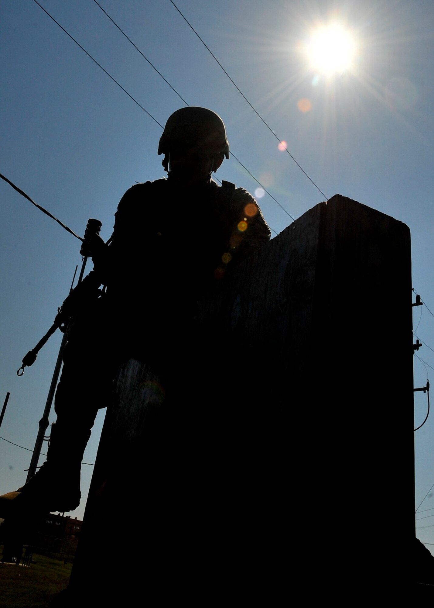 Master Sgt. Christopher Greek, 51st Security Forces Squadron flight chief, crosses an 8-foot wall during the confidence course portion of the Combat Readiness Course Sept. 27, 2011. The confidence course is aimed to test participants both physically and mentally with the overall goal of ensuring their prepared to defend Osan Air Base at a moment’s notice. (U.S. Air Force photo/Senior Airman Adam Grant)     