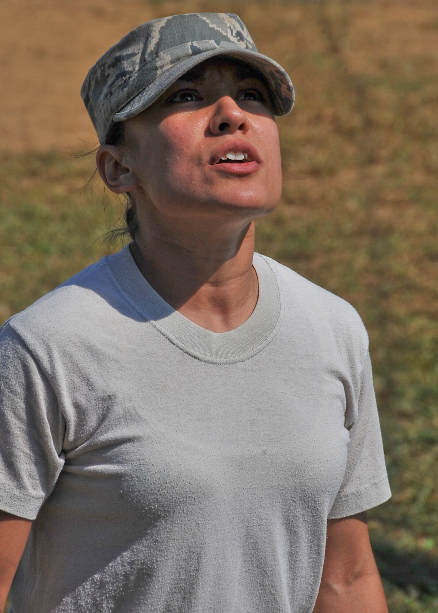 Staff Sgt. Kelly Portillo, 51st Security Forces Squadron phase one instructor, observes as members of the 51st Security Forces Squadron attempt to cross an 8-foot wall during the Combat Readiness Course Sept. 27, 2011. The Combat Readiness Course happens once a month and is offered to all new security forces members. (U.S. Air Force photo/Senior Airman Adam Grant)     