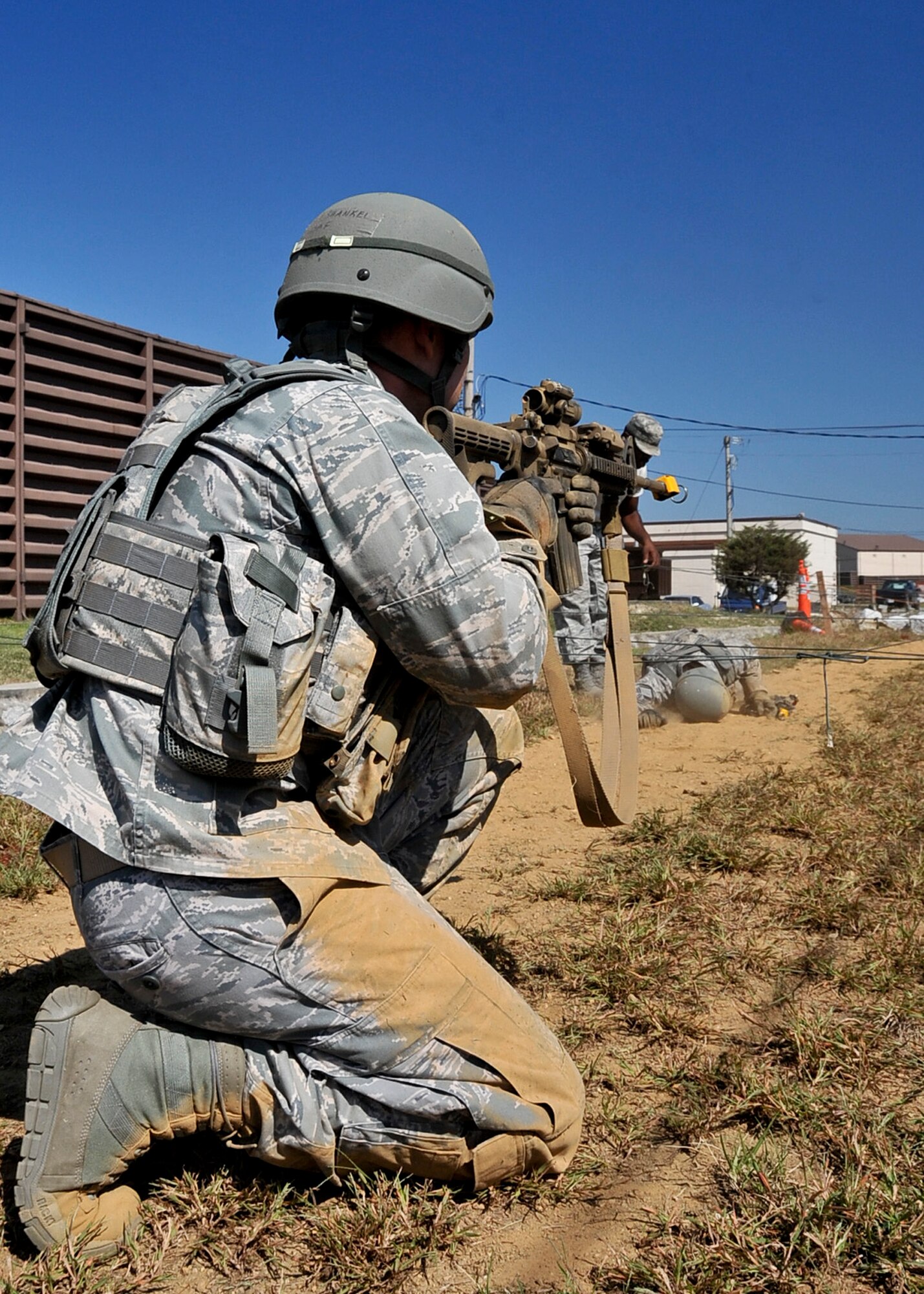 1st Lt. Israel Shankel, 51st Security Forces Squadron flight commander, provides cover while members of his team make their way through the confidence course Sept. 27, 2011. During the confidence course members answer knowledge questions, perform sprints, tire rolls, low crawl for 30 yards, maneuver over an 8-foot wall, litter carry and injured team member for 400 meters and compete in a weapons challenge. (U.S. Air Force photo/Senior Airman Adam Grant)     