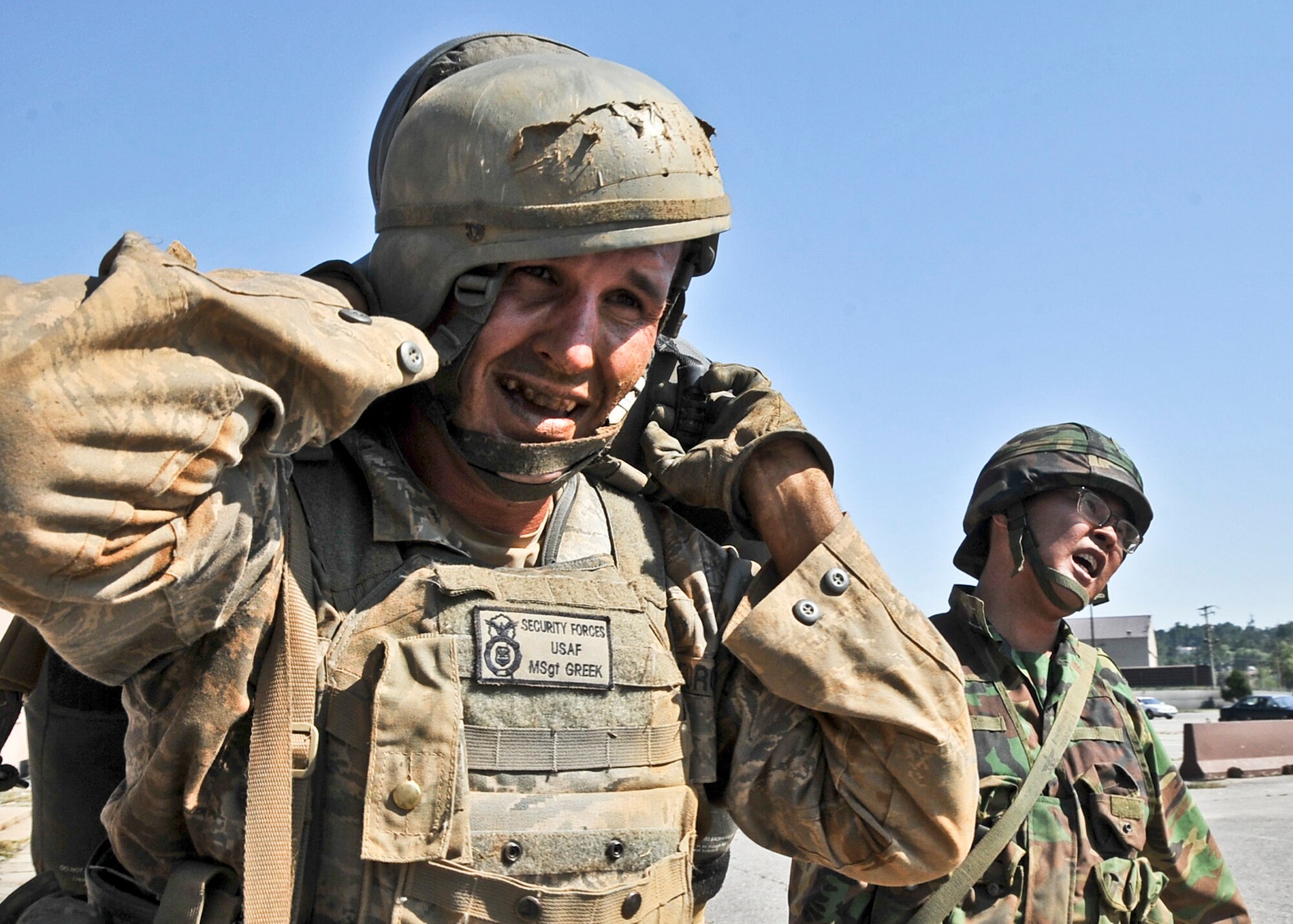 Master Sgt. Christopher Greek, 51st Security Forces Squadron flight chief, carries a simulated casualty during the confidence course Sept. 27, 2011. During the confidence course members answer knowledge questions, perform sprints, tire rolls, low crawl for 30 yards, maneuver over an 8-foot wall, litter carry and injured team member for 400 meters and compete in a weapons challenge. (U.S. Air Force photo/Senior Airman Adam Grant)        