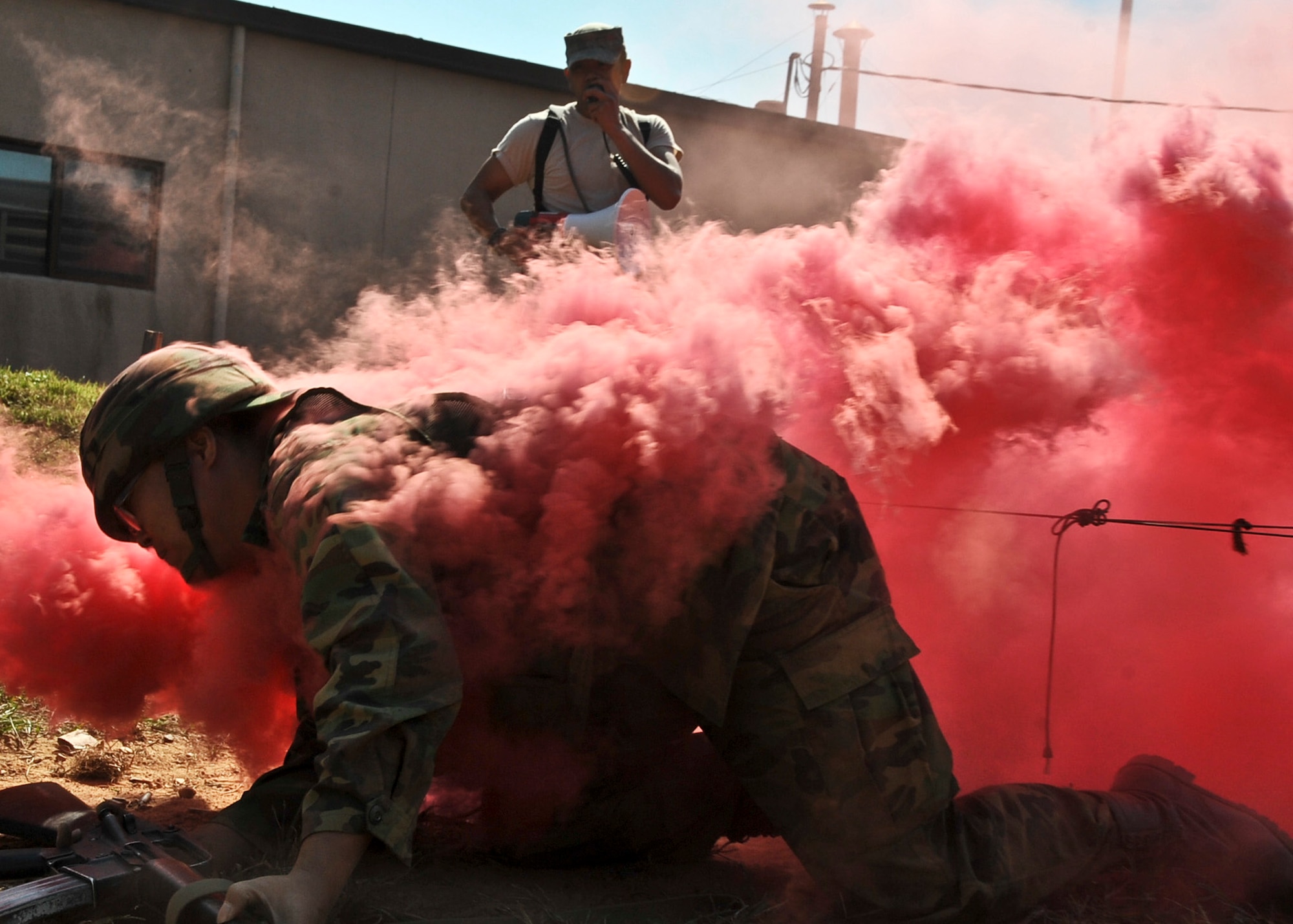 Staff Sgt. Joseph McDowell, 51st Security Forces Squadron combat readiness course instructor, observes as a member of the Republic of Korea’s Air Police finishes the low crawl portion of the confidence course Sept. 27, 2011. The confidence course is an obstacle course that tests the participant’s abilities to survive as a team while communicating when placed in stressful situations. (U.S. Air Force photo/Senior Airman Adam Grant)     