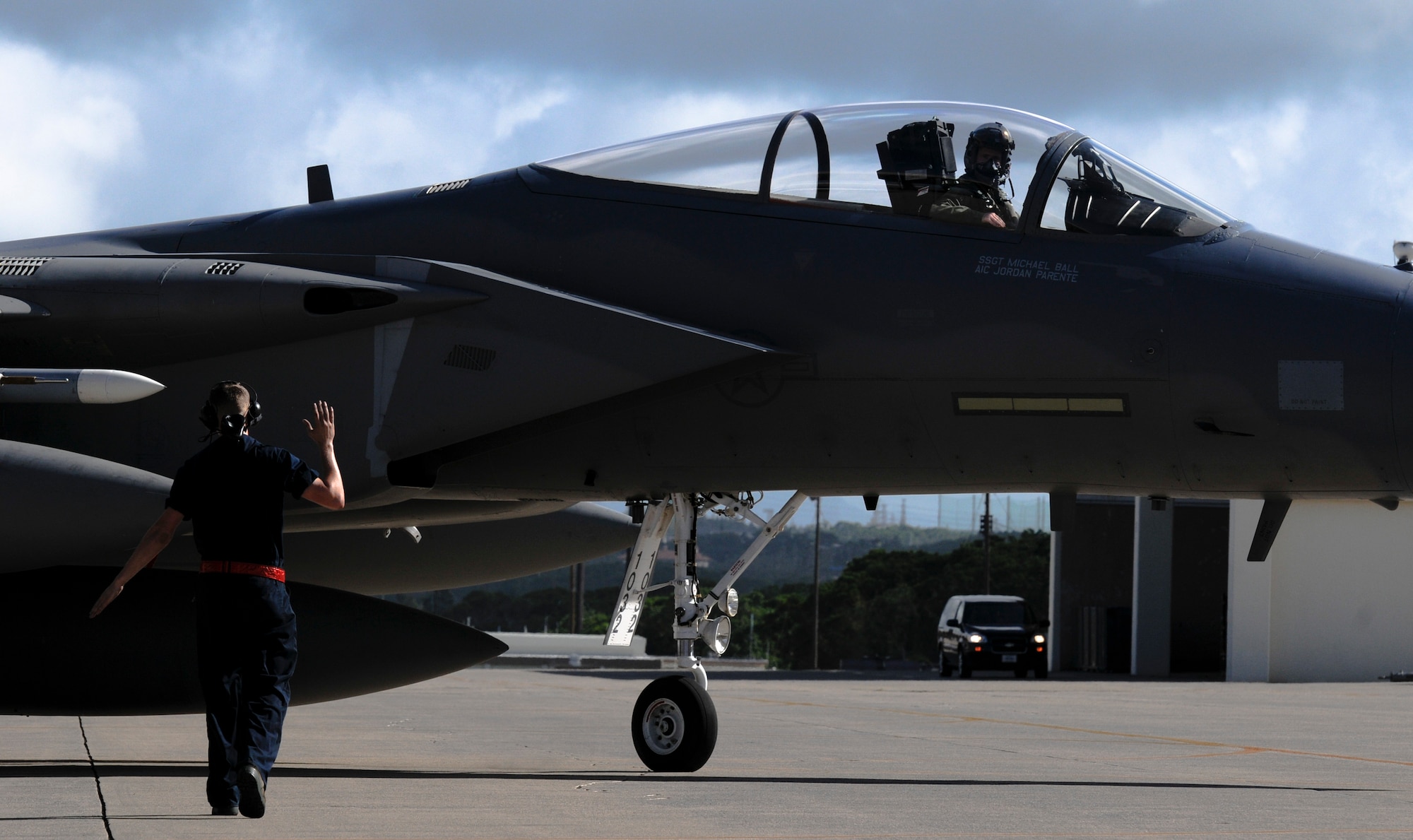 Airman 1st Class Trever King, 18th Aircraft Maintenance Squadron crew chief, marshals an F-15 Eagle fighter jet onto the flightline for takeoff on Kadena Air Base, Japan, Sept. 27. With its extreme tactical characteristics, the Eagle quickly becomes a dominant force in the air and gives the U.S. military the capability to obtain and retain supremacy over the battlefield. (U.S. Air Force photo/ Airman 1st Class Maeson L. Elleman)