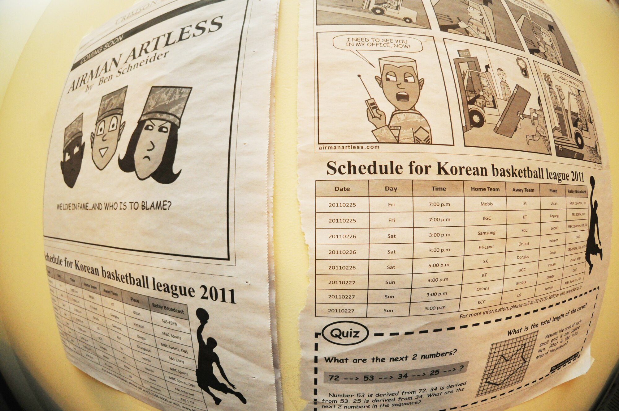 Staff Sgt. Benjamin Schneider, 8th Maintenance Squadron munitions storage crew chief, tapes his first comic strip, placed in the Crimson Sky, on his wall in his dorm at Kunsan Air Base, Republic of Korea, Sept. 28, 2011. Schneider has created 248 comic strips 16, of which have been published in the Crimson Sky newspaper. (U.S. Air Force photo by Senior Airman Brittany Y. Bateman/Released)