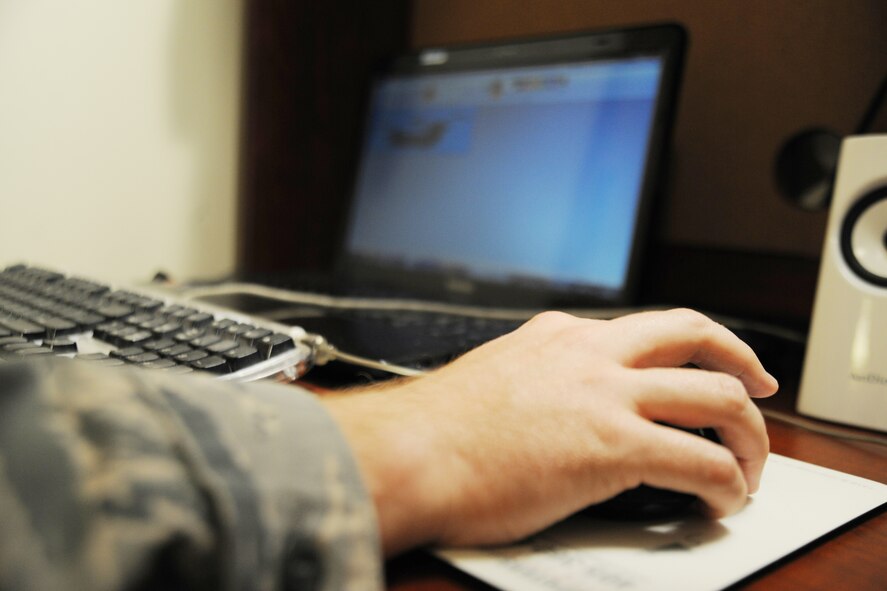 Staff Sgt. Benjamin Schneider, 8th Maintenance Squadron munitions storage crew chief, demonstrates how he puts together a comic strip at Kunsan Air Base, Republic of Korea, Sept. 28, 2011. Schneider has created 248 comic strips, 16 of which have been published in the Crimson Sky newspaper. (U.S. Air Force photo by Senior Airman Brittany Y. Bateman/Released)