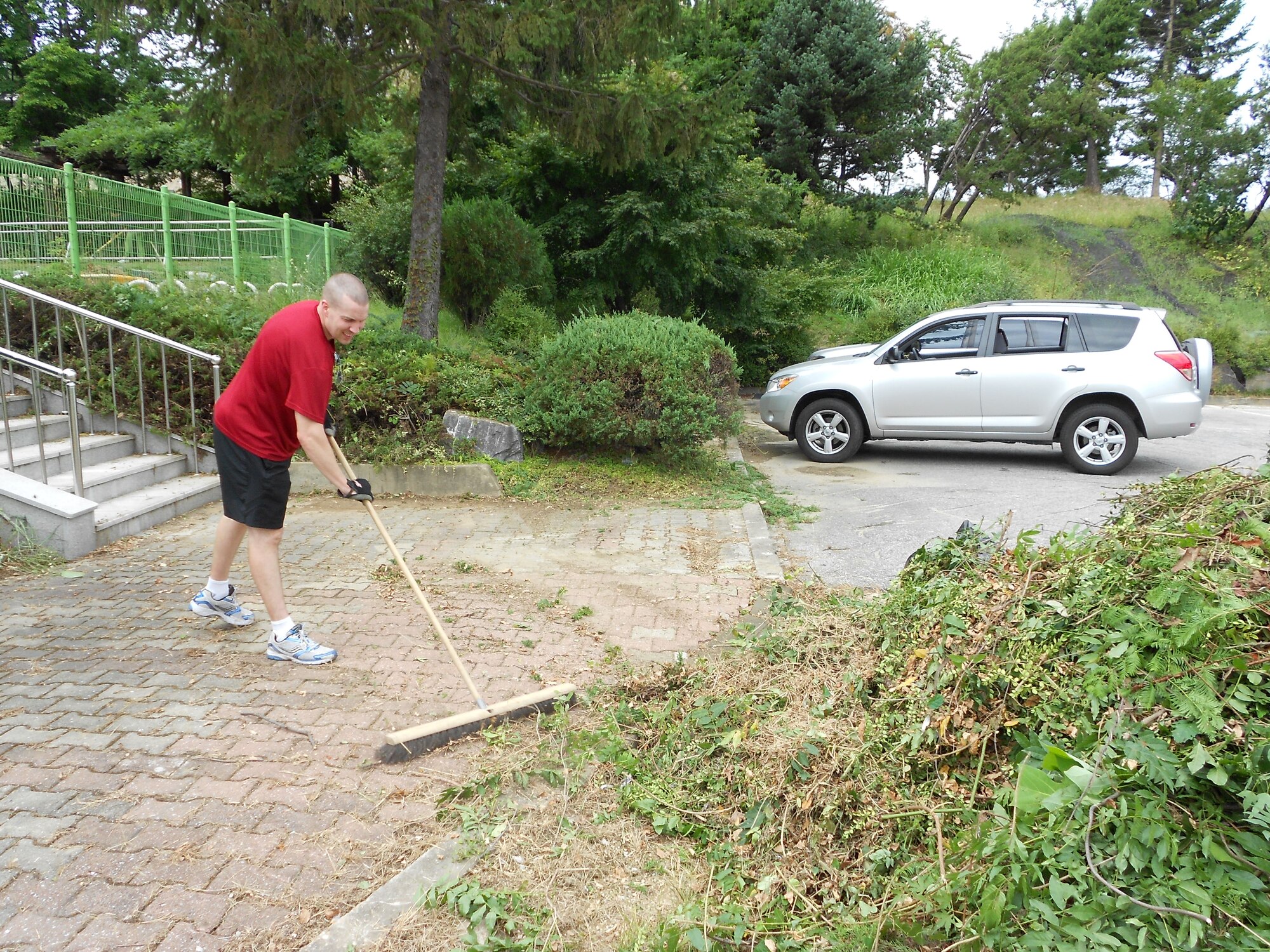 Maj. David Short, 51th Maintenance Squadron Commander, sweeps up limbs and clippings Sept. 18, 2011, at the Mustang Valley Village playground. Residents of the Hallasan Tower made the clean-up a self-help project before the closure of the playground behind their housing complex. Currently, there is no start date for the Mustang Valley Village playground renovation. It was discussed during a recent Facilities Management Board and there should be movement on the project once it gets approved. (U.S. Air Force photo/Senior Master Sgt. Stuart Camp)