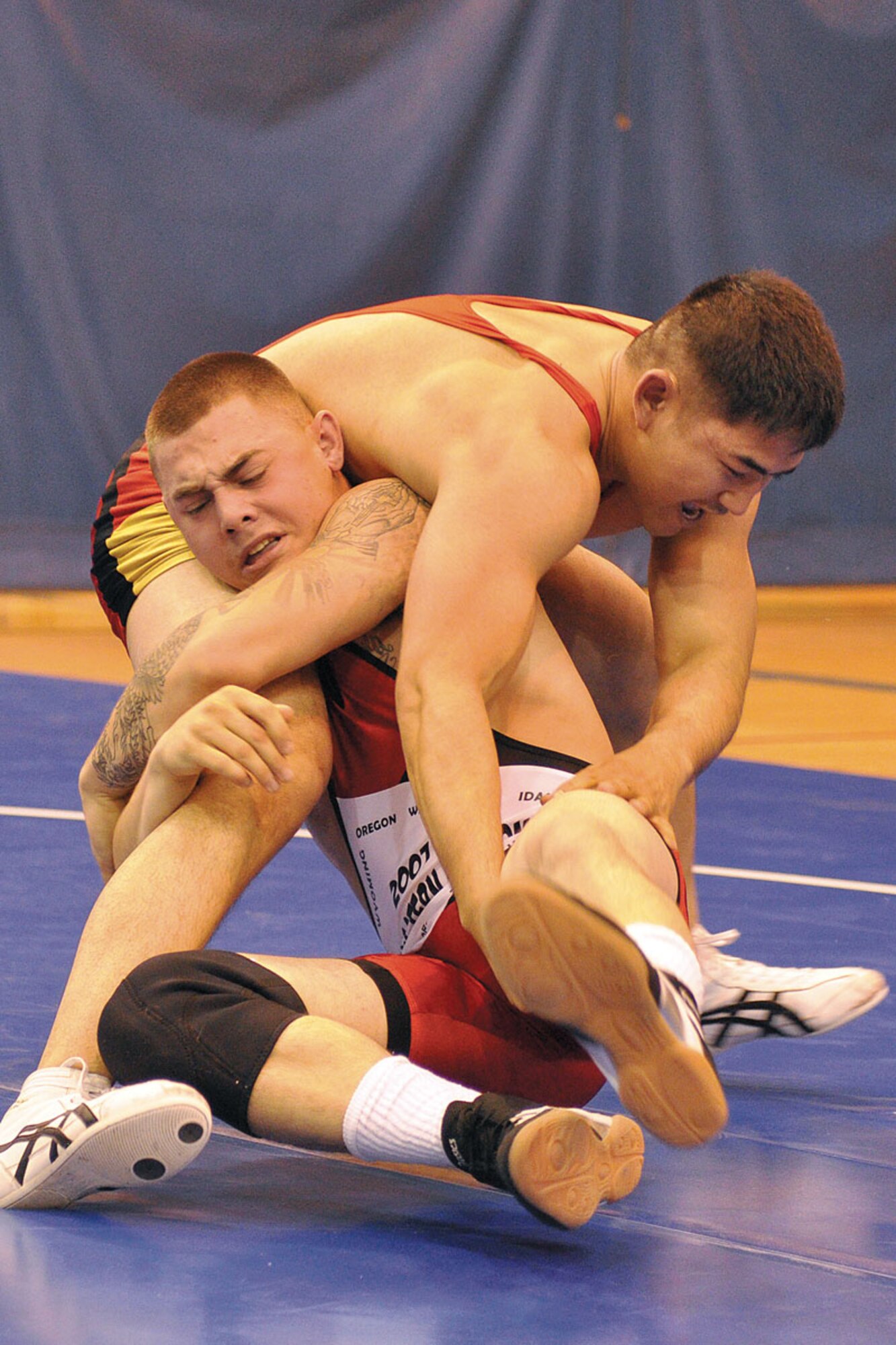 Lipho Thirakul (standing) struggles with Wayne Parker in the championship match for the 152-167.5-pound weight class as part of the JBER wrestling meet Sept. 21 at Buckner Physical Fitness Center. Thirakul, of the 98th Maintenance Company, defeated Parker, of the 425th Brigade Special Troops Battalion to win the weight class.  (U.S. Air Force photo/John Pennell)