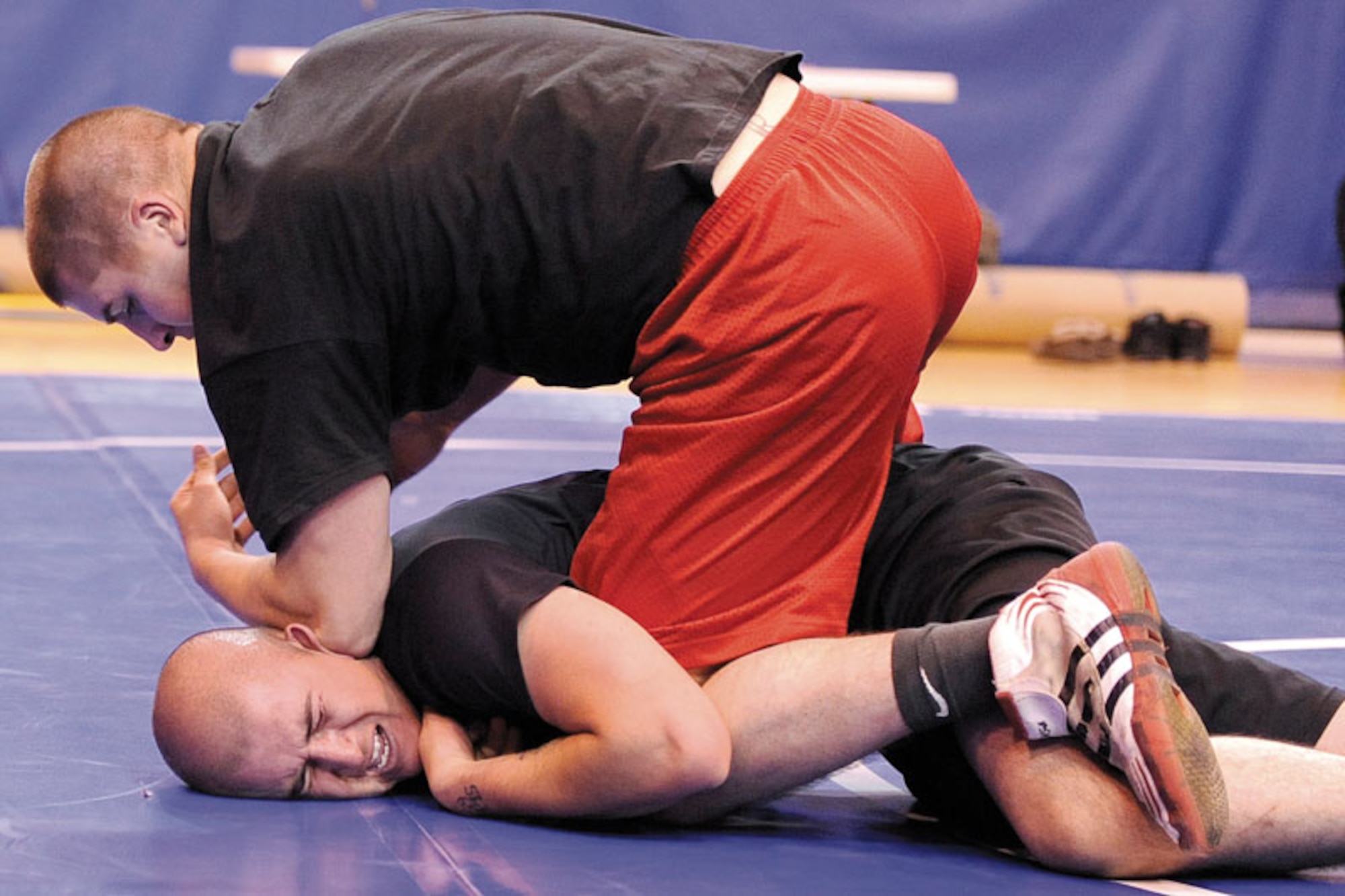 Ryan Hudson (top) takes Edrel Silva to the mat in the Joint Base Elmendorf-Richardson wrestling meet Sept. 21 at Buckner Physical Fitness Center. Hudson, a paratrooper from D Company, 3rd Battalion (Airborne), 509th Infantry Regiment, defeated Silva, from the 95th Chemical Company, to advance to the championship match where he won top honors in the 167.5-187.5-pound weight class. (U.S. Air Force photo/John Pennell)