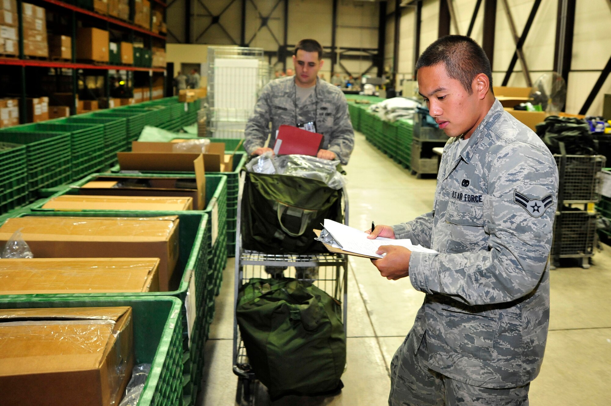 MISAWA AIR BASE, Japan – Airman 1st Class Anthony Datu, 35th Logistics Readiness Squadron, issues deployment gear during an initial readiness response exercise here Sept. 28. The purpose of the exercise is to test the 35th Fighter Wing’s ability to generate aircraft and deploy combat power anywhere they are asked to deploy to. (U.S. Air force photo/ Staff Sgt. Nathan Lipscomb)