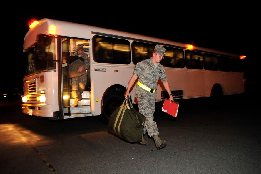 MISAWA AIR BASE, Japan – Role players exit a bus to receive deployment gear during an initial readiness response exercise here Sept. 28.  The purpose of the exercise is to test the 35th Fighter Wing’s ability to generate aircraft and deploy combat power anywhere they are asked to deploy to. (U.S. Air force photo/ Staff Sgt. Nathan Lipscomb)