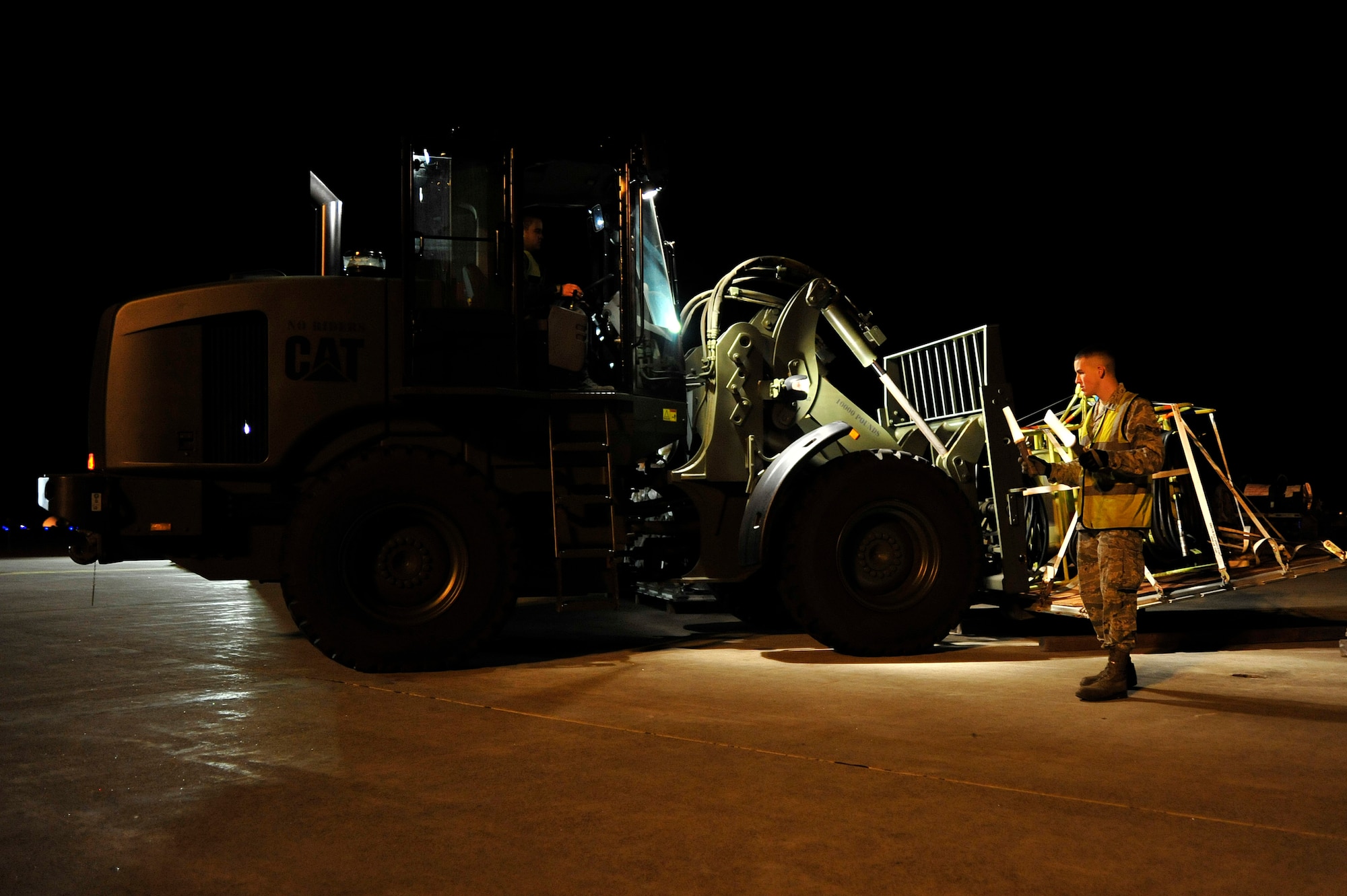 MISAWA AIR BASE, Japan -- Airmen from the 35th Logistics Readiness Squadron, move cargo to the flight line during an initial readiness response exercise here Sept. 28. The purpose of the exercise is to test the 35th Fighter Wing’s ability to generate aircraft and deploy combat power anywhere they are asked to deploy to. (U.S. Air force photo/ Staff Sgt. Nathan Lipscomb)