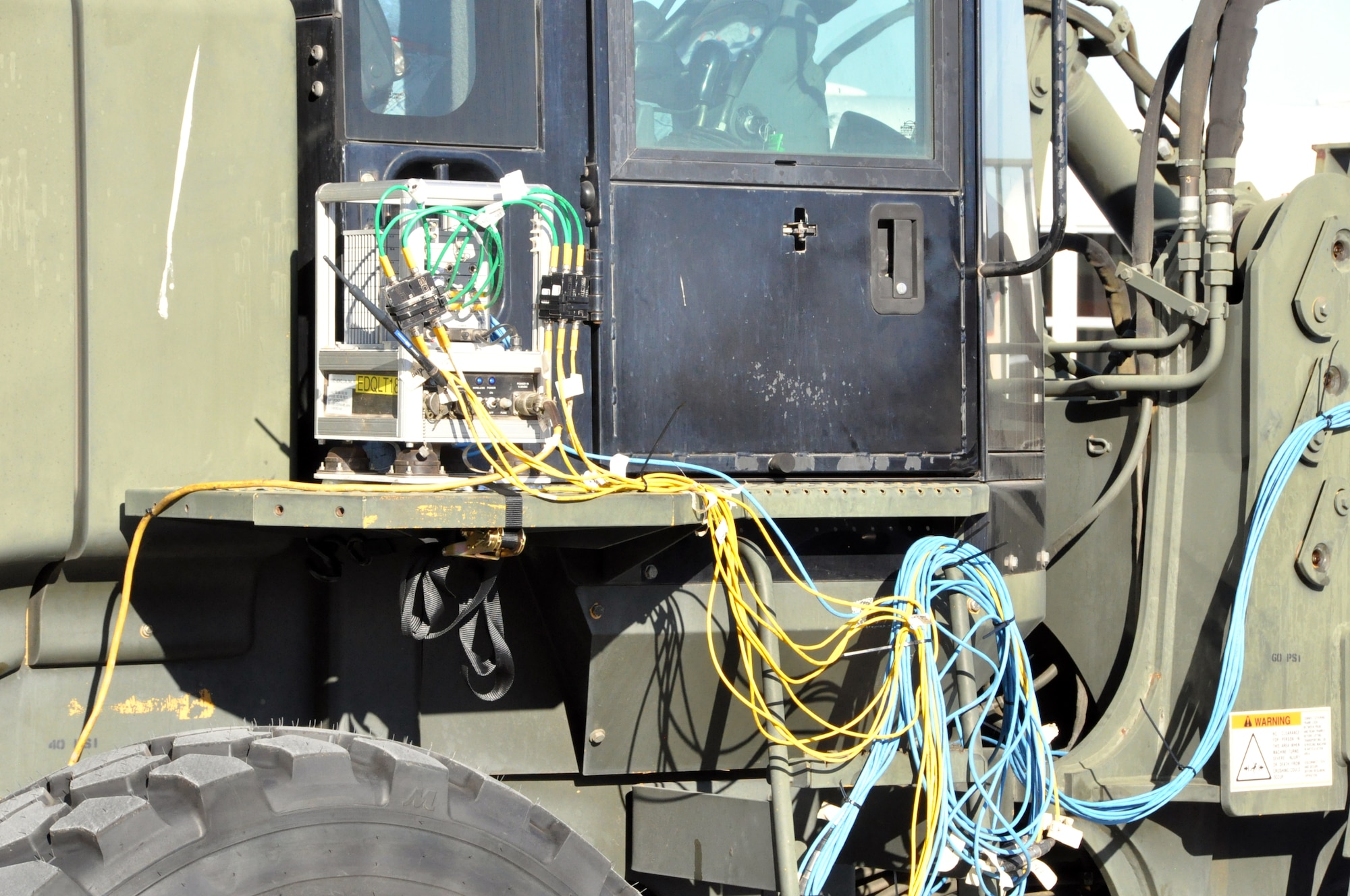Special test equipment is fitted to an all-terrain forklift Sep. 21 on the flightline at Travis. (U.S. Air Force photo/ Staff Sgt. Harrower)