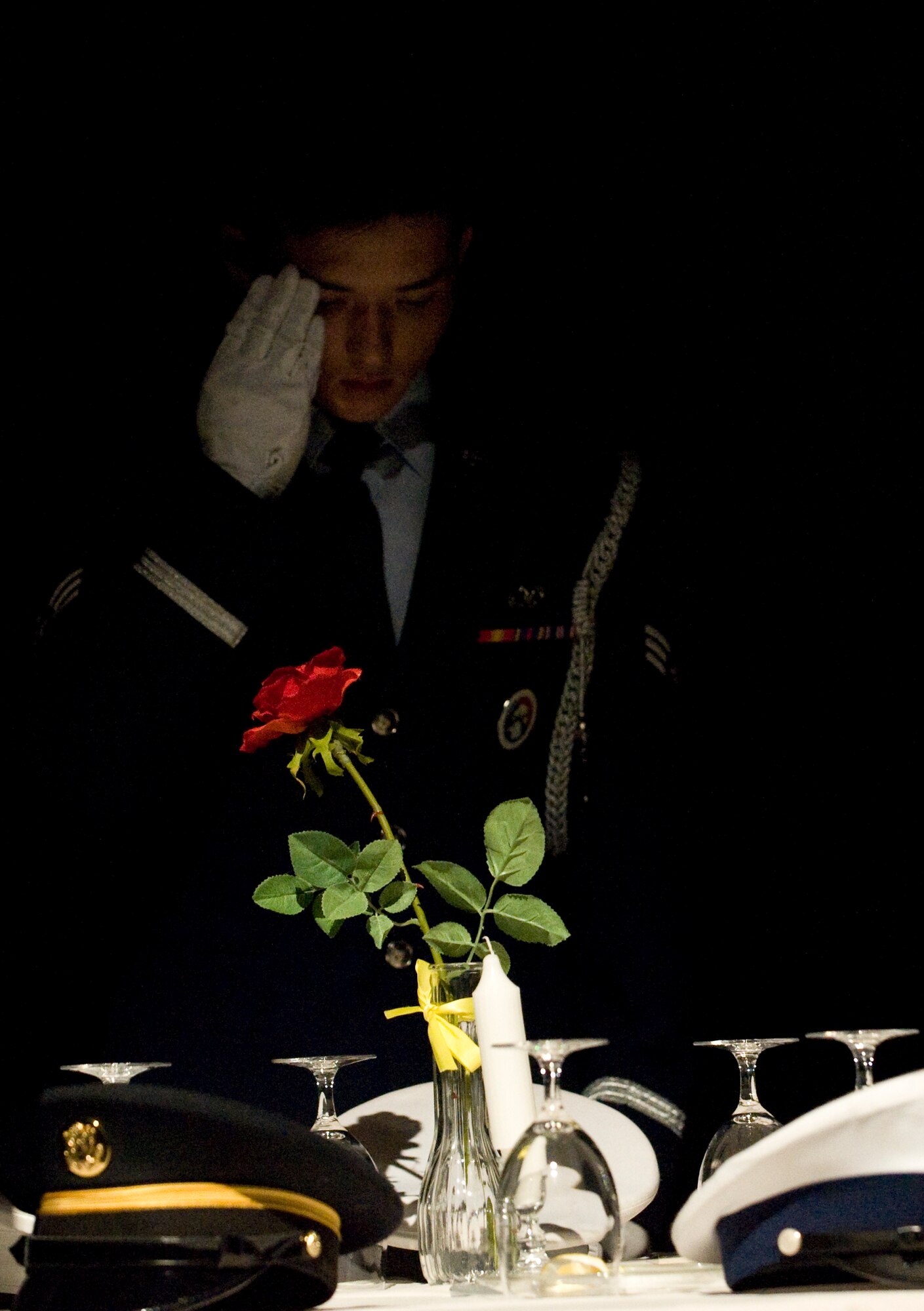 U.S. Air Force Senior Airman Devin Carrigan, Nellis Air Force Base Honor Guard member, renders a salute during the POW/MIA remembrance ceremony at the Las Vegas Air Force Ball Sept. 24, 2011, at the Bellagio Hotel and Casino. The Air Force Ball provided more than 800 Airmen an opportunity to celebrate the 64th Anniversary of the United States Air Force. (U.S. Air Force photo by Staff Sgt. Christopher Hubenthal/Released)

