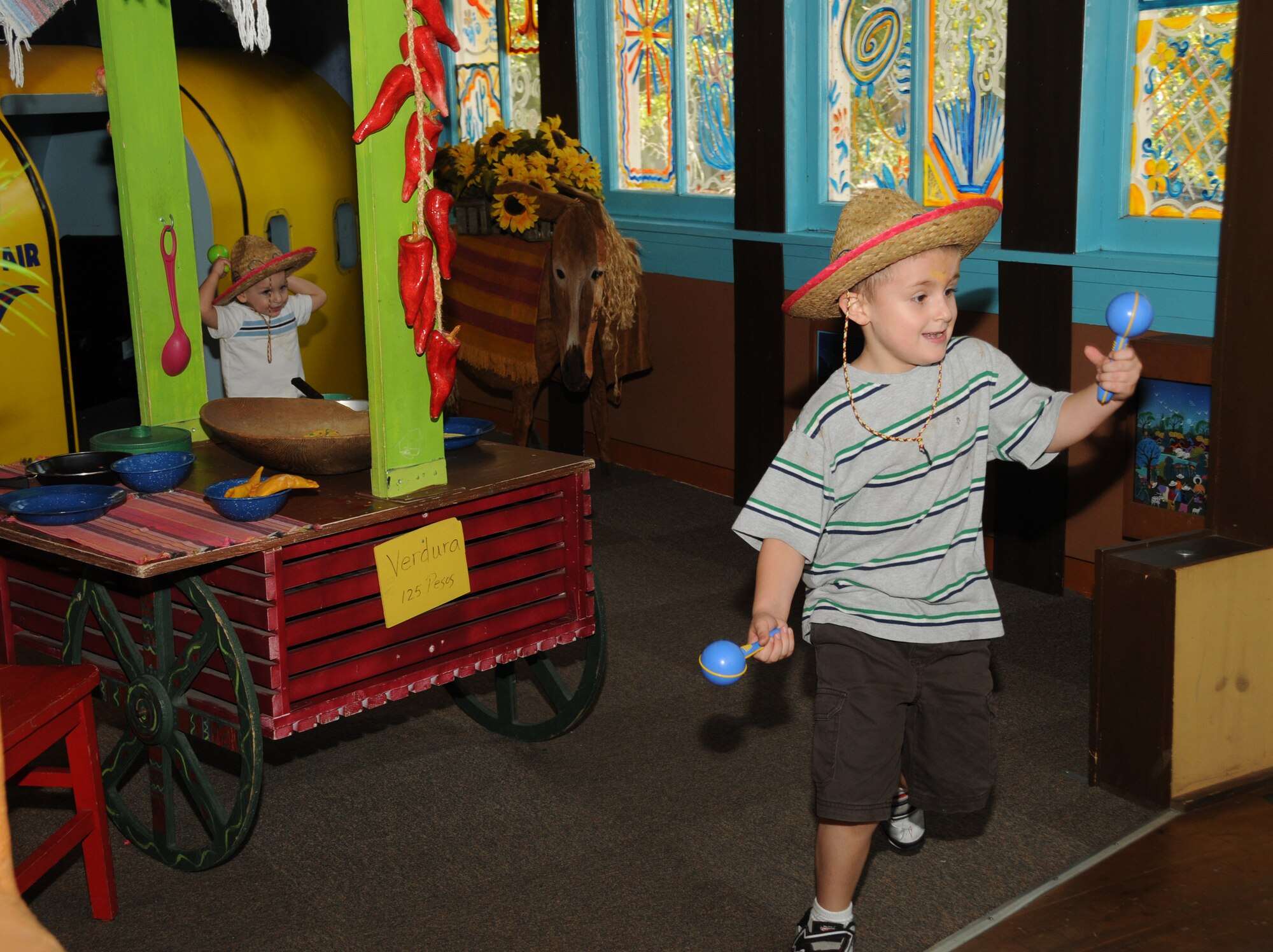 Two-year-old Gabriel Van Dusen, left, and his 6-year-old brother, Johnathan, try on costumes Sept. 24, during an outreach program at Lynn Meadows Discovery Center, Gulfport.  Their parents are Carrie and Airman 1st Class Shane van Dusen, 345th Airlift Squadron.  The fun day was sponsored by the airman and family readiness center’s exceptional family member program and Child Find to help families connect with available community and base resources.  (U.S. Air Force photo by Kemberly Groue)