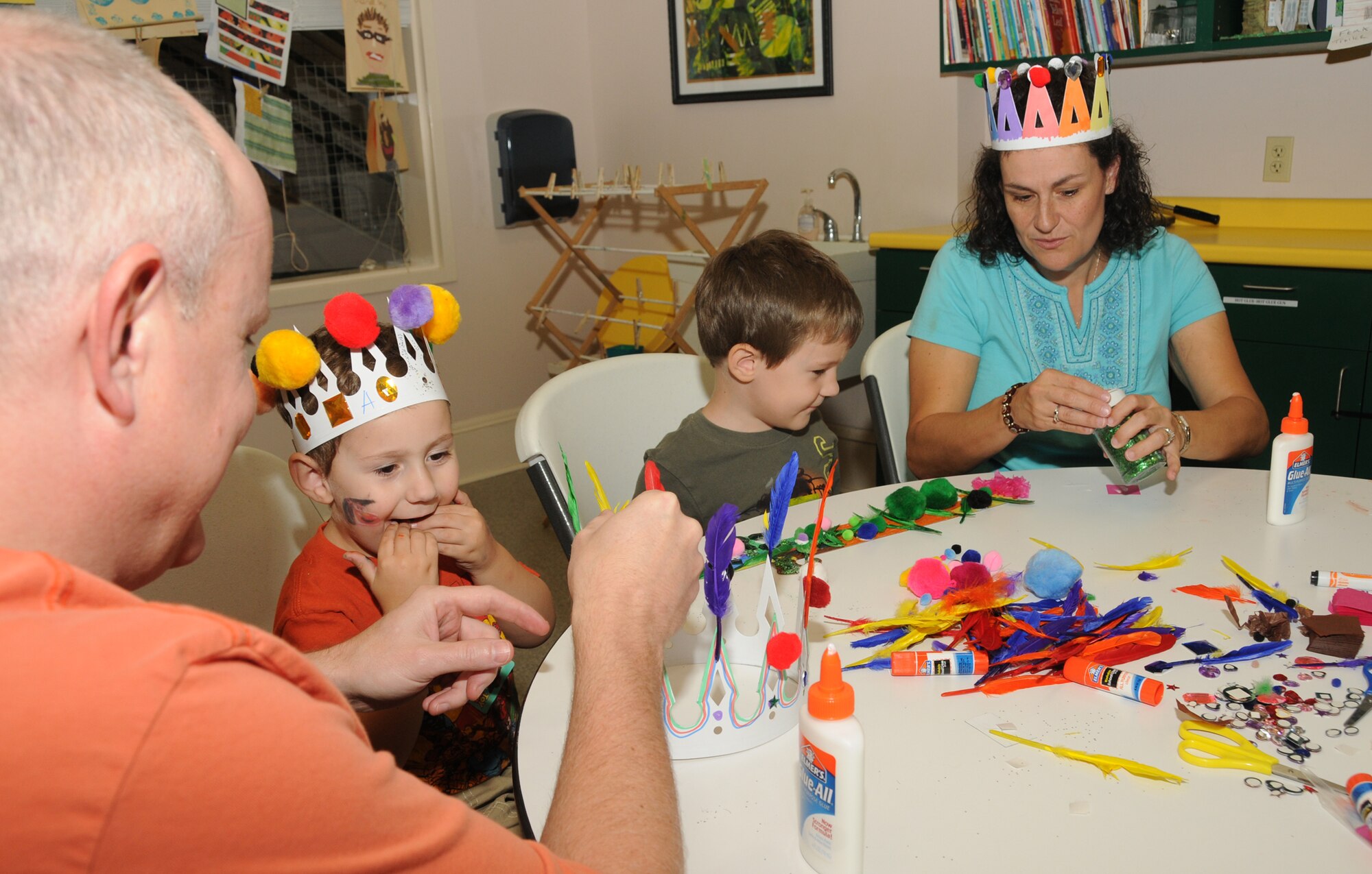 From left, Capt. Dean Doré, sons Alexander and Nathan and their mother, Tara Doré, make crowns and swords Sept. 24, at an outreach program at Lynn Meadows Discovery Center, Gulfport.  Alexander is 3 and Nathan is 5 years old. The fun day was sponsored by the airman and family readiness center’s exceptional family member program and Child Find to help families connect with available community and base resources.  (U.S. Air Force photo by Kemberly Groue)
