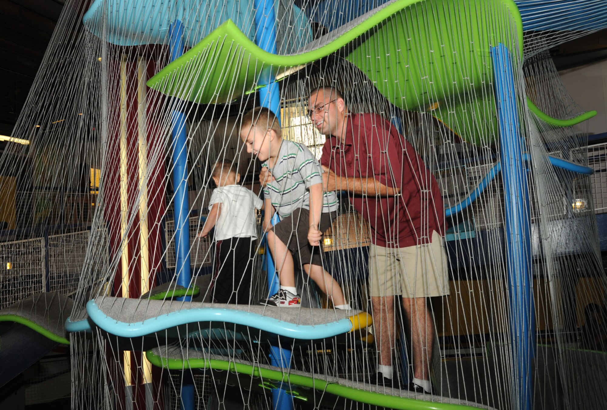 From left, Gabriel Van Dusen, 2, and his brother Johnathan, 6, scale the heights of
a central maze with the help of their father, Airman 1st Class Shane Van Dusen, 345th Airlift Squadron, during an outreach program at Lynn Meadows Discovery Center Sept. 24.  The program was sponsored by the airman and family readiness center’s exceptional family member program and Child Find to help families connect with available community and base resources.  The boys’ mother is Carrie Van Dusen.  (U.S. Air Force photo by Kemberly Groue)