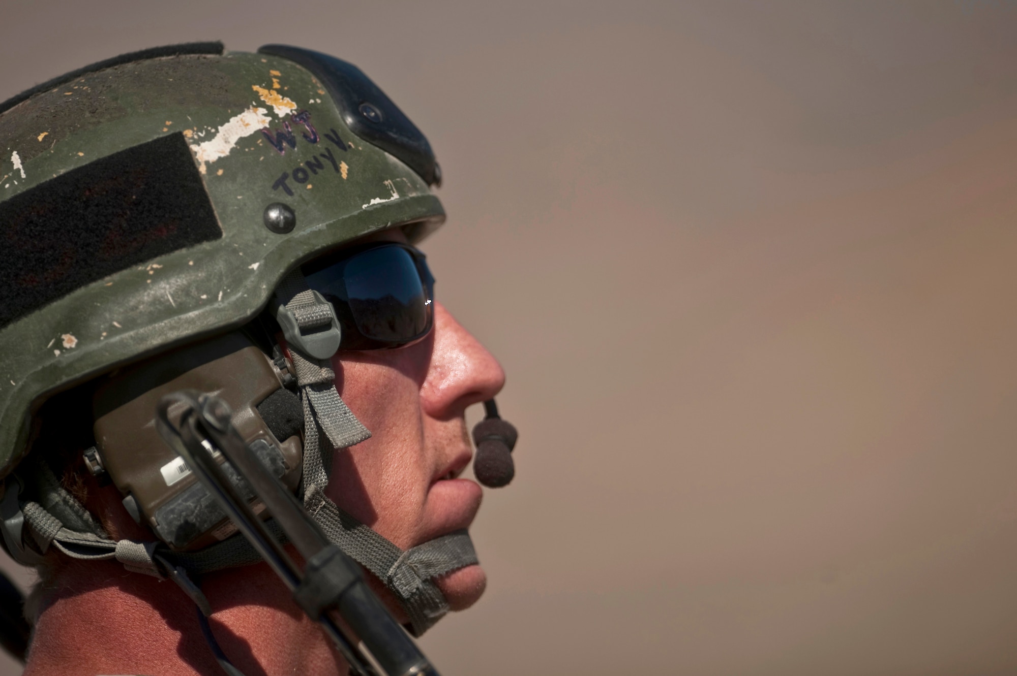U.S. Air Force Tech. Sgt. Aaron Switzer, 21st Special Tactics Squadron joint terminal attack controller, communicates with aircraft while looking toward the sky during a close air support training mission Sept. 23, 2011, at the Nevada Test and Training Range.  Joint Terminal Attack Controllers perform proficiency training with U.S. Air Force Weapons School students during the close air support phases of the Weapons School six-month, graduate-level instructor course. (U.S. Air Force photo by Tech. Sgt. Michael R. Holzworth/Released)
