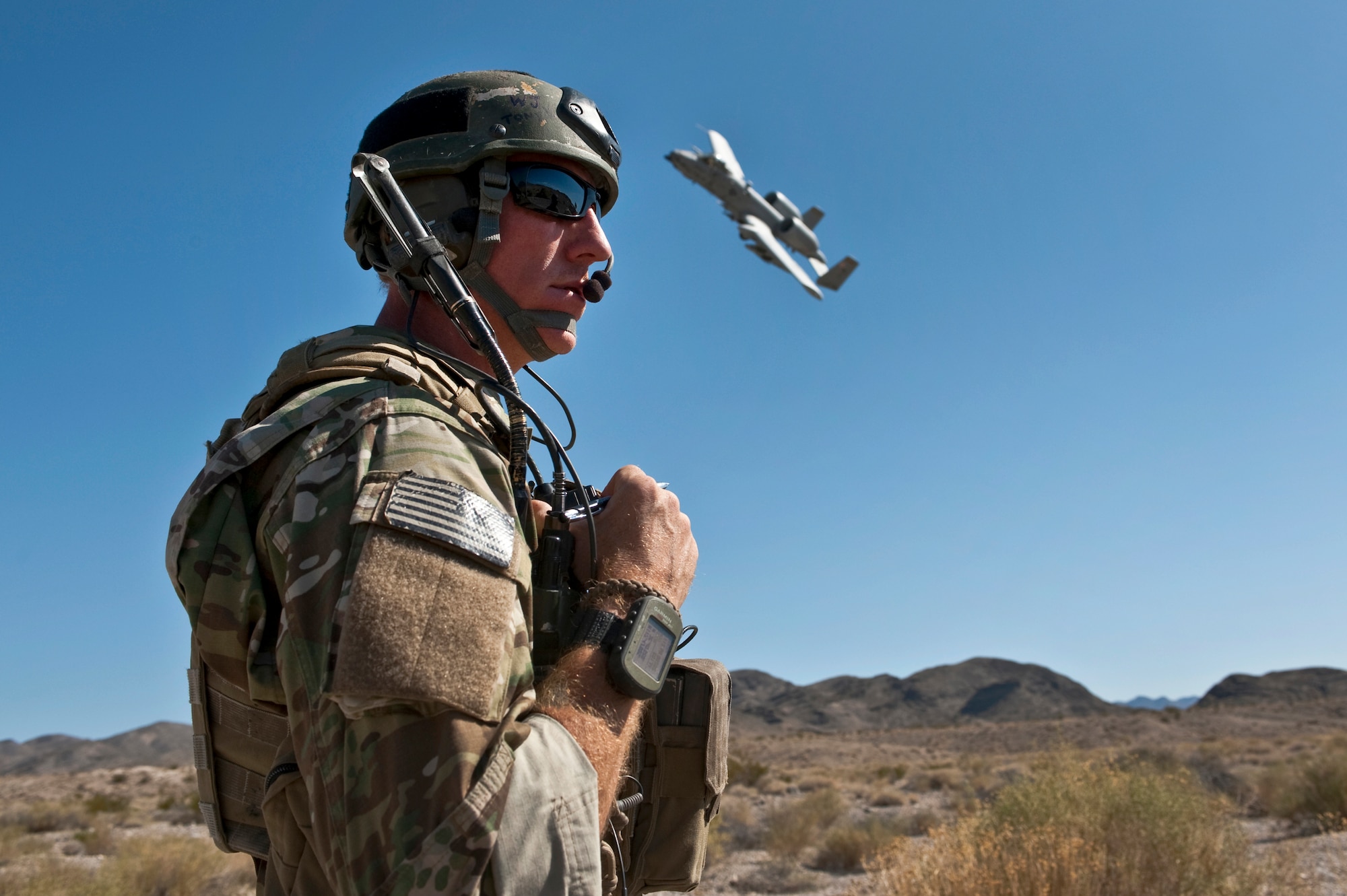 U.S. Air Force Tech. Sgt. Aaron Switzer, 21st Special Tactics Squadron joint terminal attack controllers, from Pope Field, N.C., uses a radio to communicate with A-10 Thunderbolt II aircraft during a close air support training mission Sept. 23, 2011, at the Nevada Test and Training Range.  Joint Terminal Attack Controllers perform proficiency training with U.S. Air Force Weapons School students during the close air support phases of the Weapons School six-month, graduate-level instructor course. (U.S. Air Force photo by Tech. Sgt. Michael R. Holzworth/Released)

