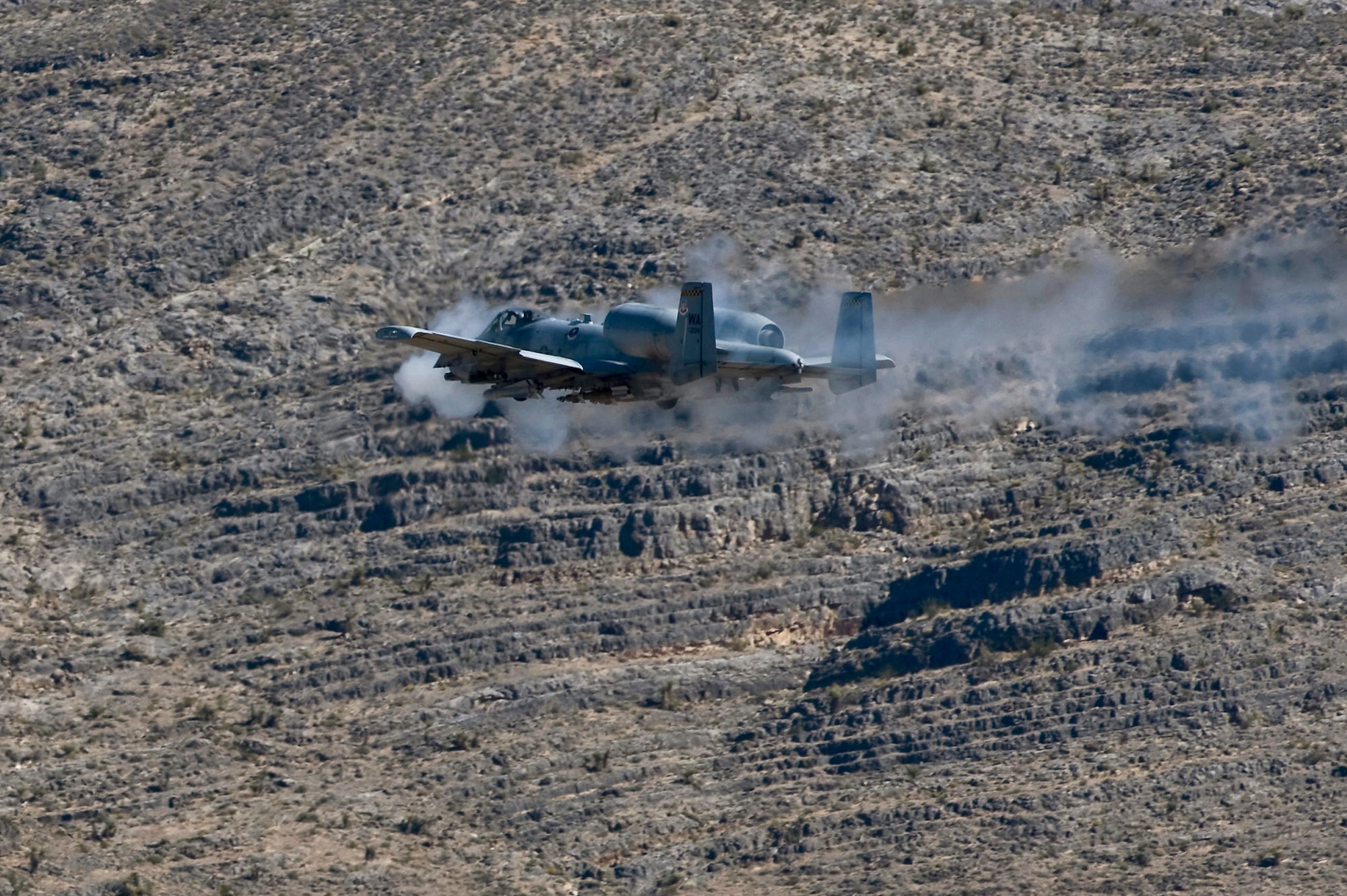 A U.S. Air Force A-10 Thunderbolt II with the U.S. Air Force Weapons School, Nellis Air Force Base, Nev., fires its 30mm GAU-8/A Avenger Gatling cannon during close air support training mission Sept. 23, 2011, over the Nevada Test and Training Range.  U.S. Air Force Weapons School students participate in many combat training missions over  the NTTR during the six-month, graduate-level instructor course held at Nellis Air Force Base, Nev. (U.S. Air Force photo by Senior Airman Brett Clashman/Released)
