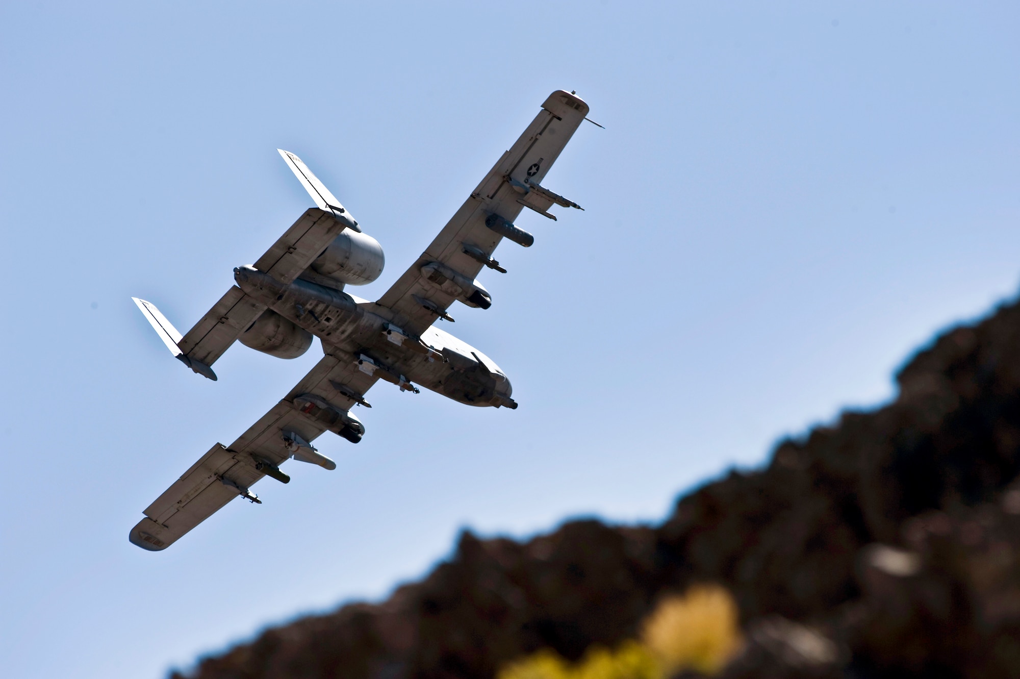 A U.S. Air Force A-10 Thunderbolt II with the U.S. Air Force Weapons School, Nellis Air Force Base, Nev., provides close air support Sept. 23, 2011, over the Nevada Test and Training Range.  U.S. Air Force Weapons School students participate in many combat training missions over  the NTTR during the six-month, graduate-level instructor course held at Nellis Air Force Base, Nev. (U.S. Air Force photo by Senior Airman Brett Clashman/Released)
