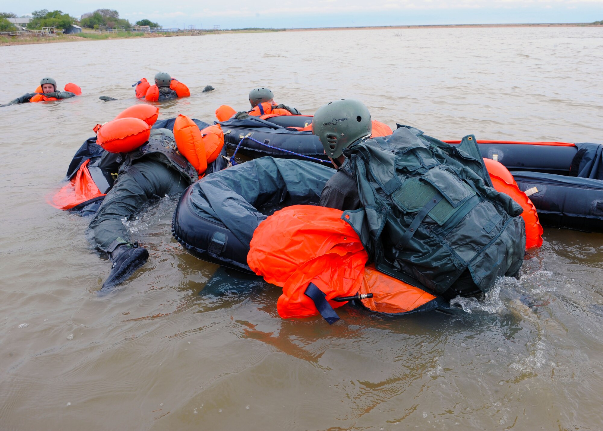 Dyess airmen climb aboard one man life rafts Sept. 22, 2011 during water survival training at Fort Phantom Hill Lake in Abilene, Texas. Airmen that have gone through Survival Evasion Resistance Escape training must go through additional training to stay updated and vigilant in case of real world situations. (U.S. Air Force photo by Airman 1st Class Jonathan Stefanko/ Released) 