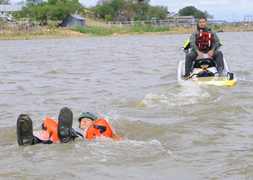 Staff Sgt. Sarah Parsley, 40th Airlift Squadron, is pulled by a jet ski Sept. 22, 2011 simulating a parachute being caught in the wind at Fort Phantom Hill Lake in Abilene, Texas. Airmen that have gone through Survival Evasion Resistance Escape training must go through additional training to stay updated and vigilant in case of real world situations. (U.S. Air Force photo by Airman 1st Class Jonathan Stefanko/ Released)