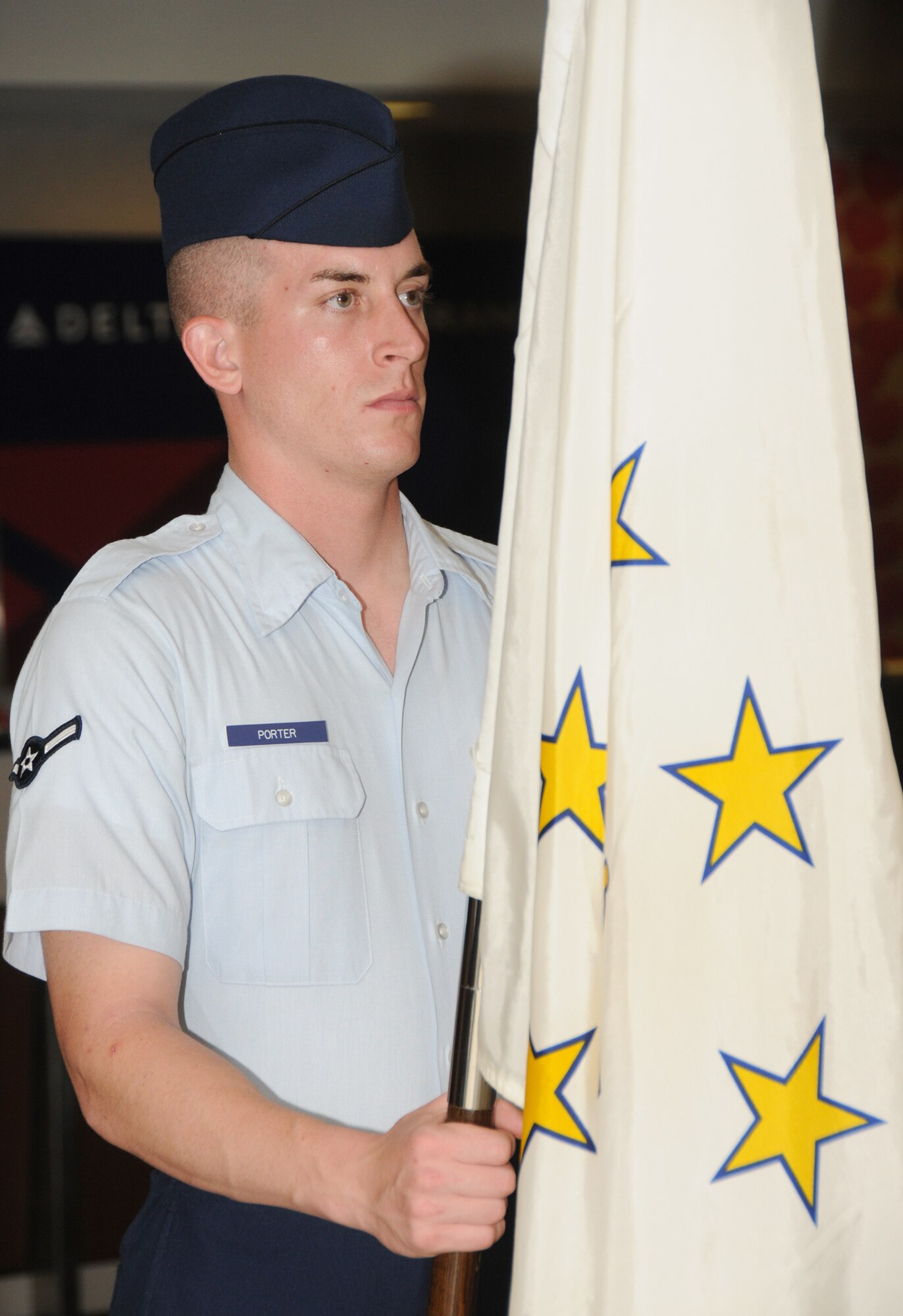 Airman Joseph Porter, 334th Training Squadron students, holds the Rhode Island flag as part of the 50 state flag team honoring members of the Mississippi Gulf Coast’s second Honor Flight Sept. 21 at the Gulfport-Biloxi International Airport.  The 86 World War II veterans visited the World War II Memorial and other Washington, D.C. landmarks and met with Mississippi Sen. Roger Wicker and Rep. Steven Palazzo.  Keesler’s Marine Corps Detachment, drum and bugle corps, honor guard and others welcomed the returning veterans.   (U.S. Air Force photo by Kemberly Groue)