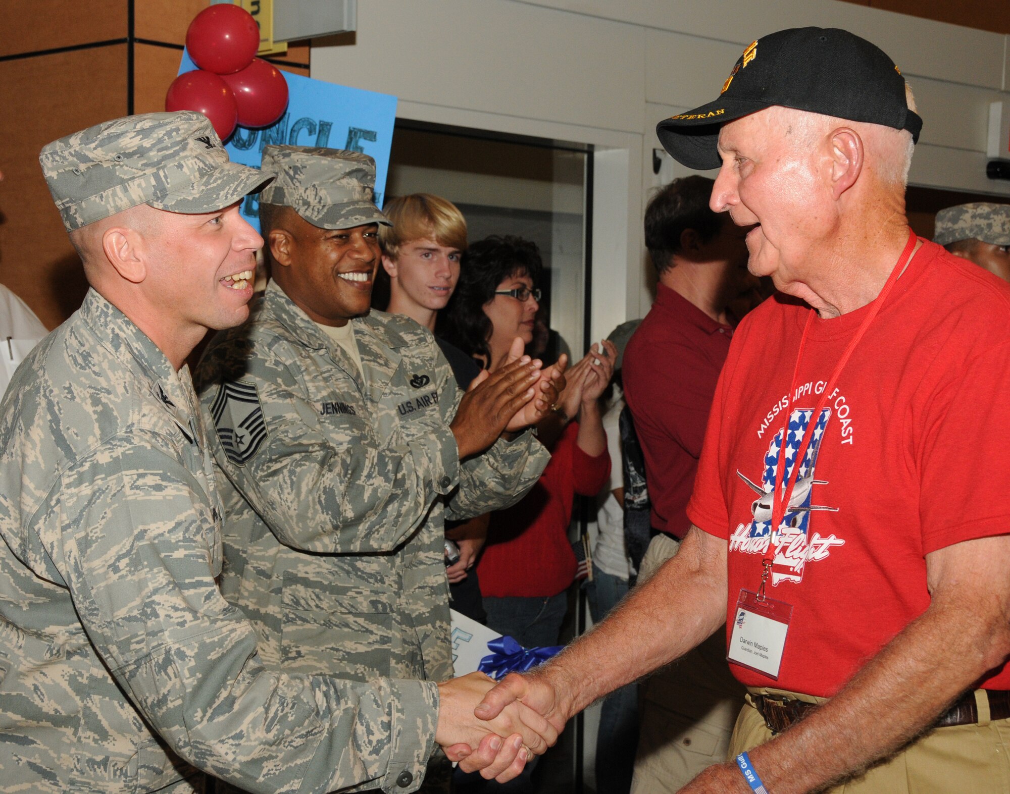 From left, Col. Glen Downing, 81st Training Wing vice commander, and Chief Master Sgt. Curtis Jennings, 81st Mission Support Group superintendent, greet Darwin Maples, World War II veteran from Lucedale, Miss., as he returns from Washington, D.C., aboard the second Mississippi Gulf Coast Honor Flight, Sept. 21. Maples was one of 86 World War II veterans and about 45 guardians who visited the World War II Memorial that was created to honor the service members who fought and the field of stars that remembers those who died. The day-long tour also took the veterans to the Vietnam Veterans Memorial, Korean War Memorial, Lincoln Memorial, Arlington National Cemetery and other sites.  (U.S. Air Force photo by Kemberly Groue)