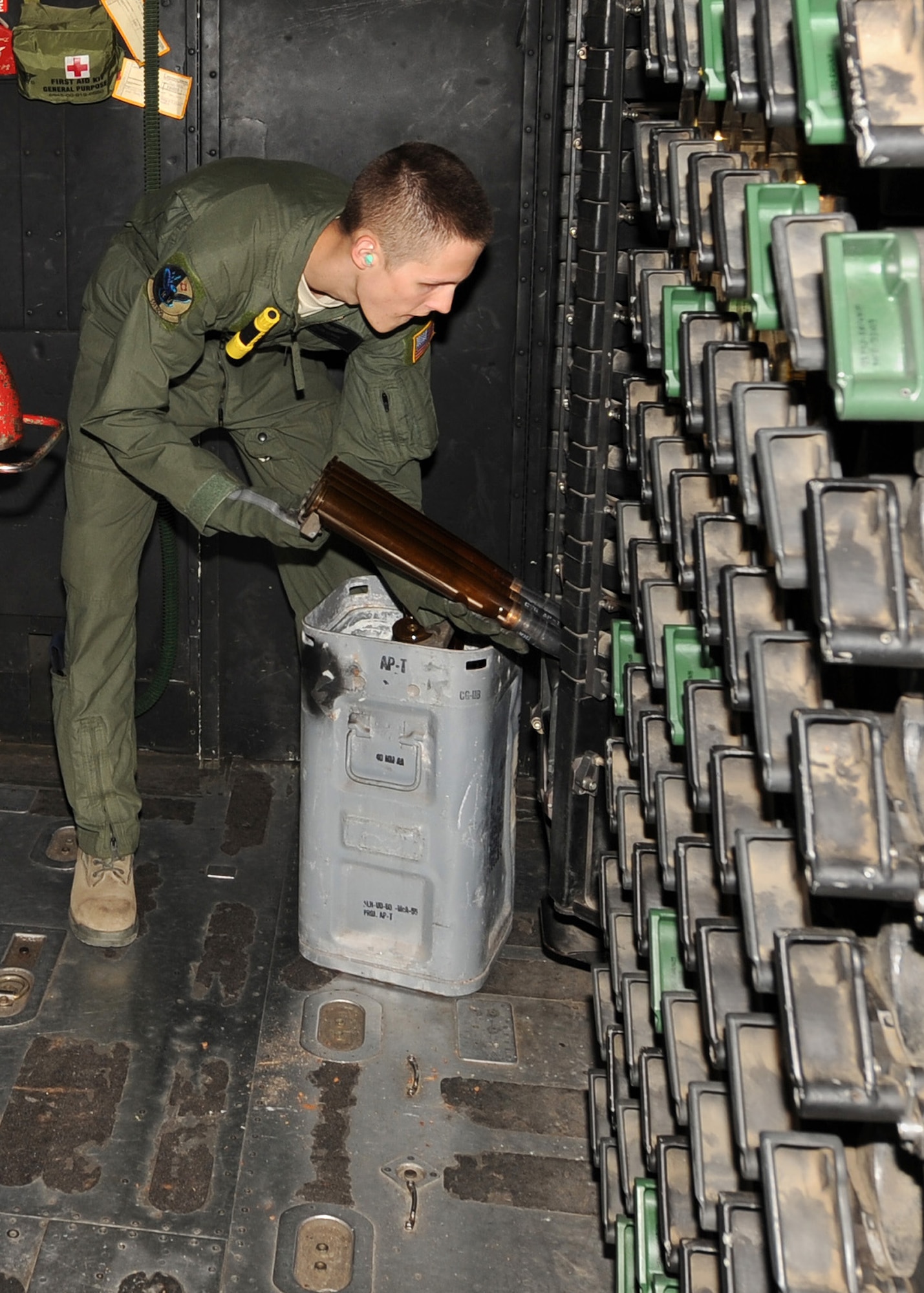 Airman 1st Class Dylan Lewark, 16th Special Operations Squadron aerial gunner, loads ammunition onto the gun rack of an AC-130H Spectre gunship during Operation Dark Night at Melrose Range, N.M., Sept. 22, 2011.This exercise is used to train special operators for mission requirements. (U.S. Air Force photo by Airman 1st Class Xavier Lockley)