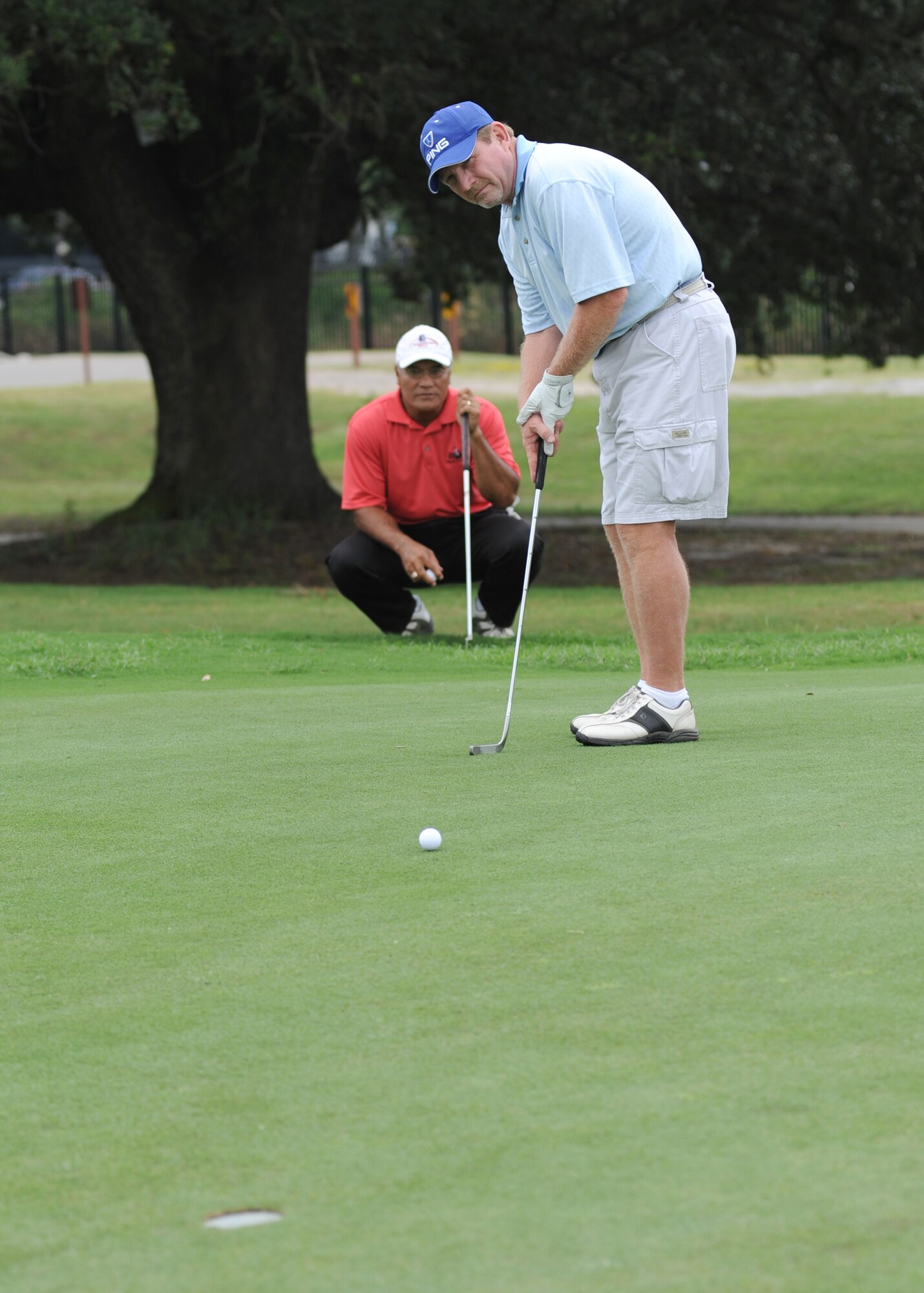 Tama Manu watches 81st Force Support Squadron teammate Gary Schafer make a
putt on Hole 4 at Bay Breeze Golf Course during the championship playoff Sept. 21.   The 81st FSS defeated the 81st Logistics Readiness Squadron to win the base intramural golf title.  (U.S. Air Force photo by Kemberly Groue)