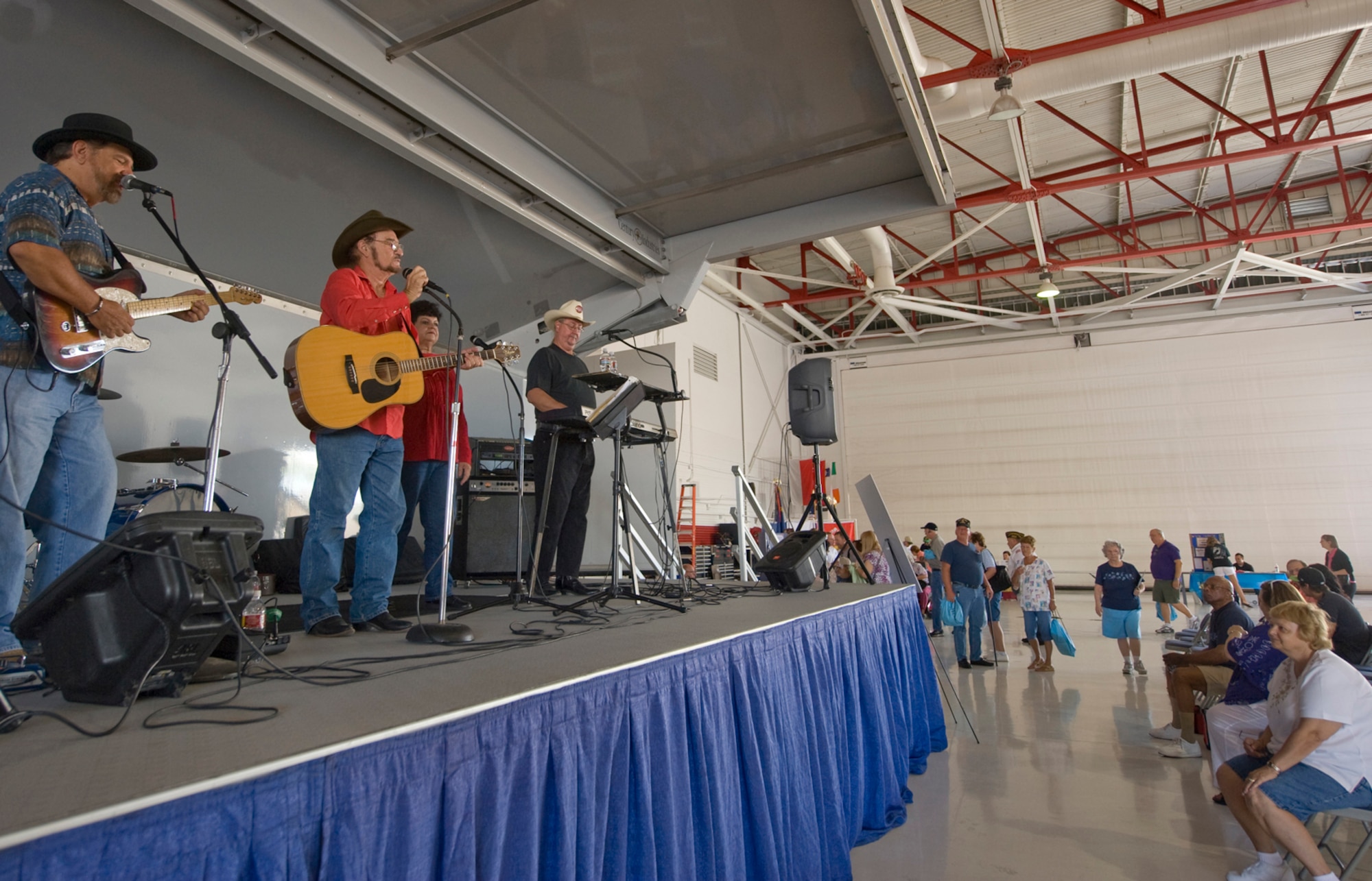 Paul Bowman Band performs for retirees during the Nellis, Creech and the Nevada Test and Training Range Retiree Appreciation Day Sept. 24, 2011, at Nellis Air Force Base, Nev. More than 800 retirees were offered health screenings and enjoyed demonstrations, entertainment, door prizes and lunch at the Thunderbird hangar.  (U.S Air Force photo by Senior Airman Stephanie Rubi/Released)