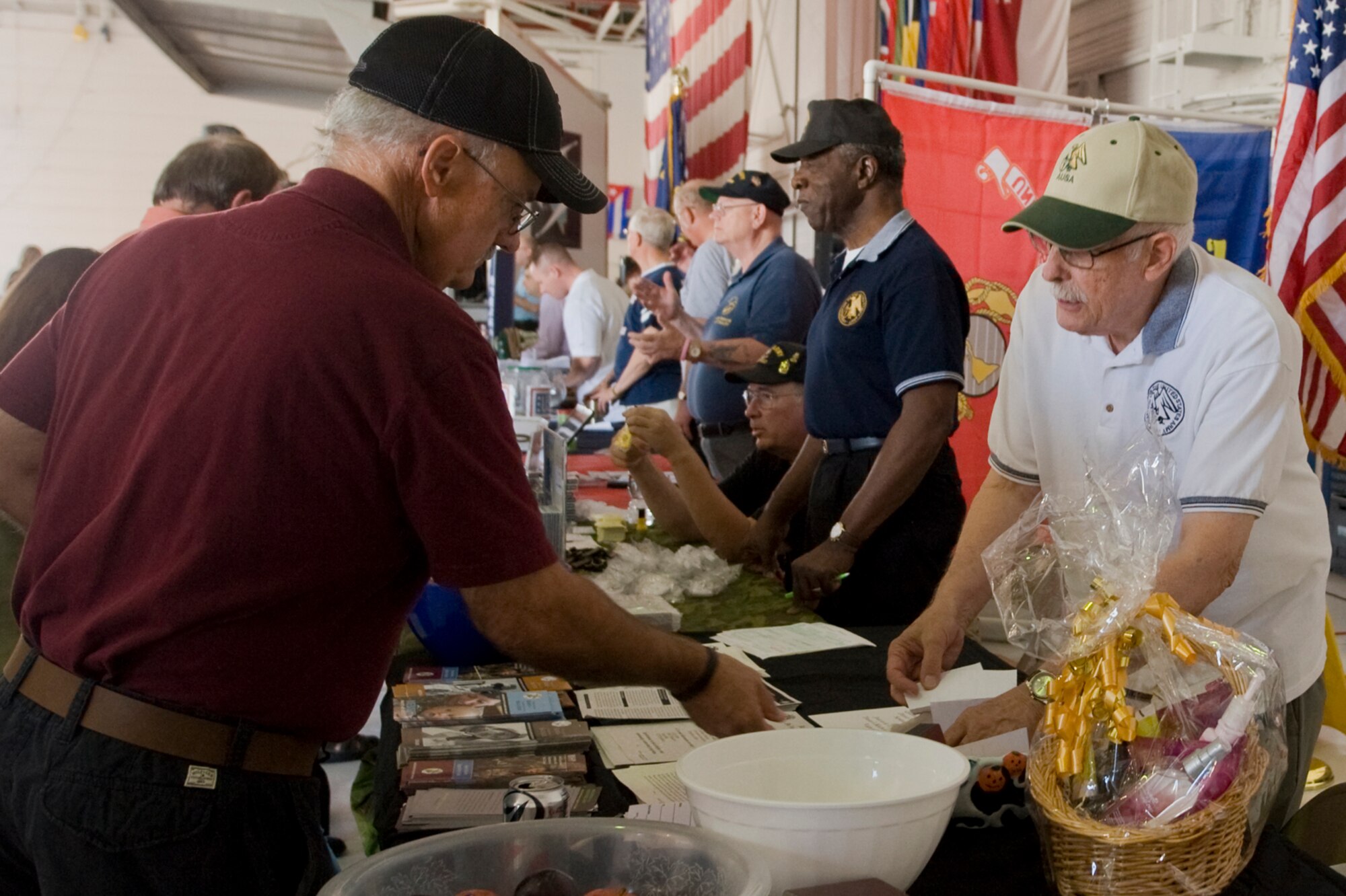 Retired U.S. Air Force Master Sgt. Billy Maggart enters a raffle with Len Schwitzer, Association of the Army, during the Nellis, Creech and the Nevada Test and Training Range Retiree Appreciation Day Sept. 24, 2011, at Nellis Air Force Base, Nev. More than 800 retirees were offered health screenings and enjoyed demonstrations, entertainment, door prizes and lunch at the Thunderbird hangar. 
 (U.S Air Force photo by Senior Airman Stephanie Rubi/Released)