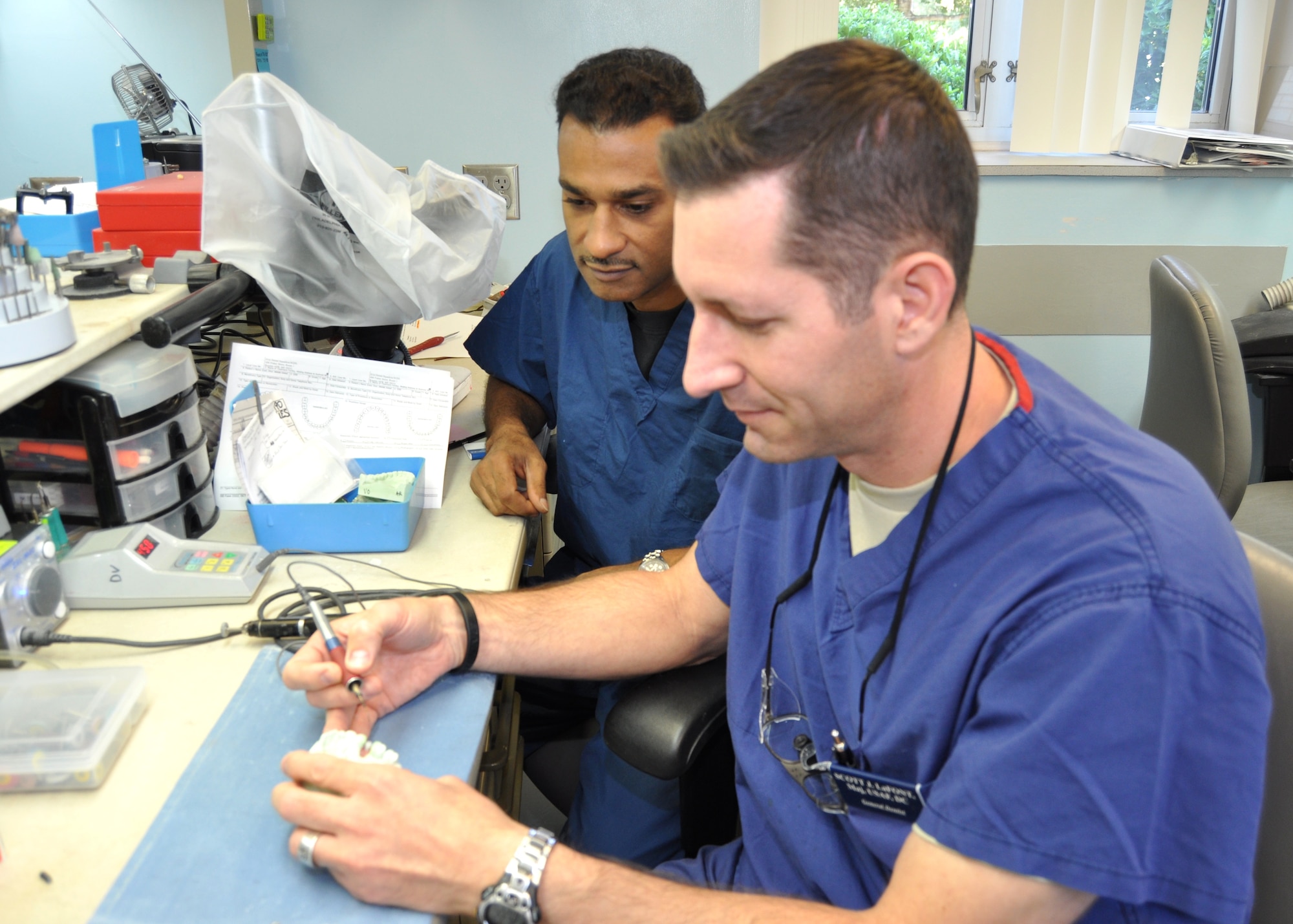 Maj. (Dr.) Scott Lafont, 81st Dental Squadron, fabricates an implant crown in the 81st DS dental lab as Lt. Col. (Dr.) Andre Henriques, 81st DS, watches.  (U.S. Air Force photo by Steve Pivnick)