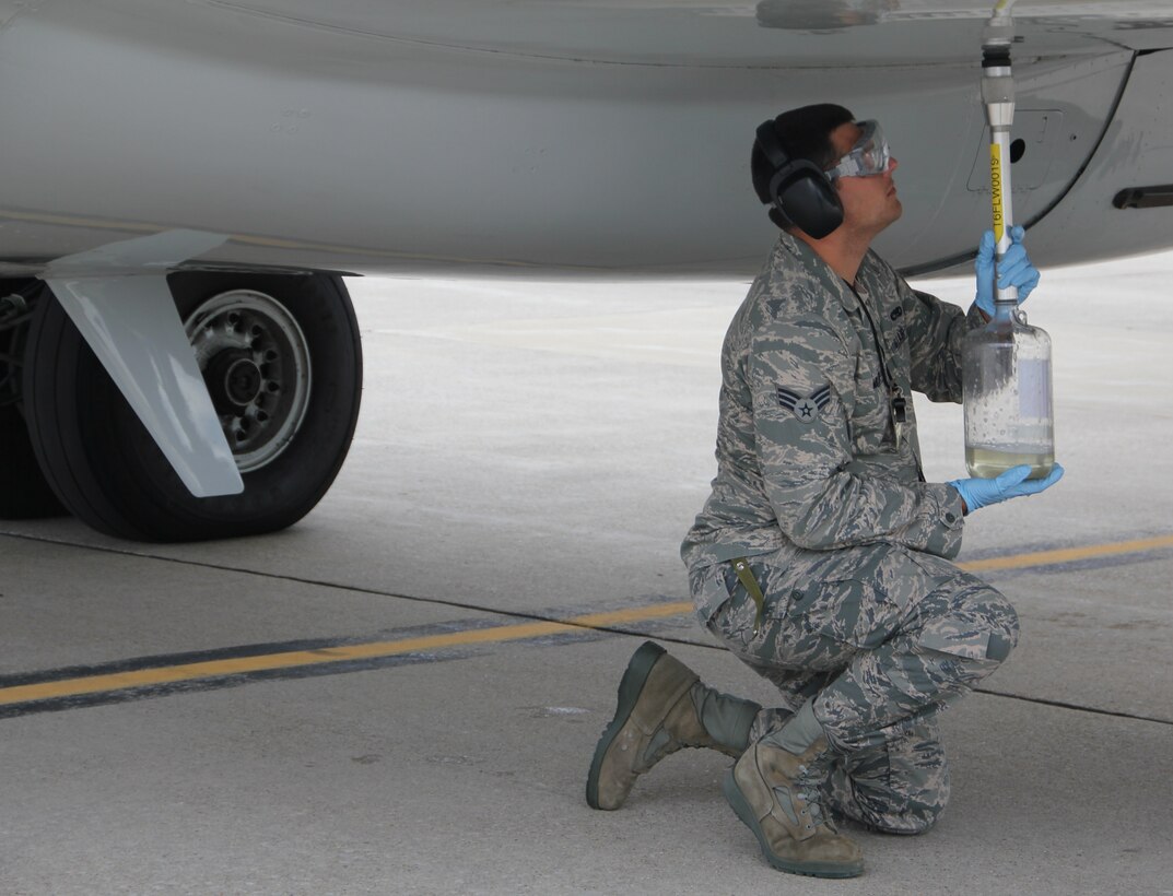 Senior Airman Sam Miller, 932nd Maintenance Squadron, collects excess fuel from VC-9 (tail 1863) just prior to its final flight as an Air Force Reserve aircraft.   (U.S. Air Force photo/Tech. Sgt. Dan Oliver)