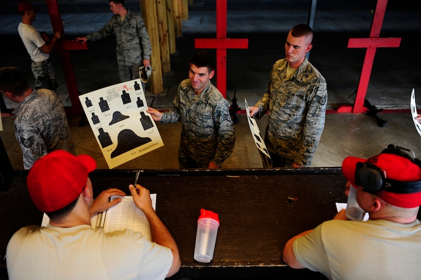 Staff Sgt. Robert Macpeek (left), and Staff Sgt. Nicholas Lile have their targets scored Sept. 7 at Joint Base Charleston-Air Base, during a Combat Arms Training and Maintenance qualifying course.  Macpeek is assigned to the 628th Logistics Readiness Squadron and Lile is assigned to the 437th Aircraft Maintenance Squadron (U.S. Air Force photo/Airman 1st Class Matthew Bruch) 
