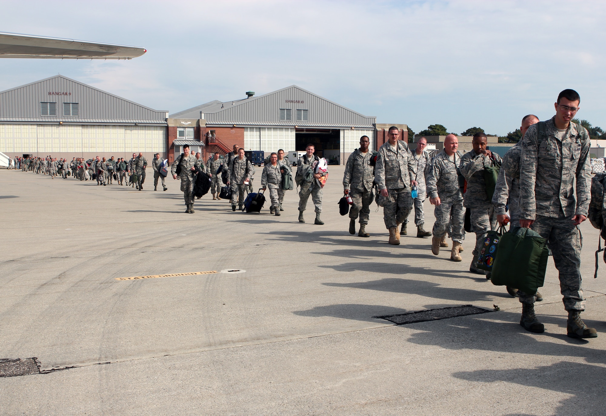 Citizen-Airmen of the 127th Wing, Michigan Air National Guard walk to an aircraft for deployment to Afghanistan from Selfridge Air National Guard Base, Mich., Sept. 25, 2011. The Airmen will be flying and supporting A-10 Thunderbolt II aircraft while deployed. (U.S. Air Force photo by SSgt. Anna-Marie Wyant)